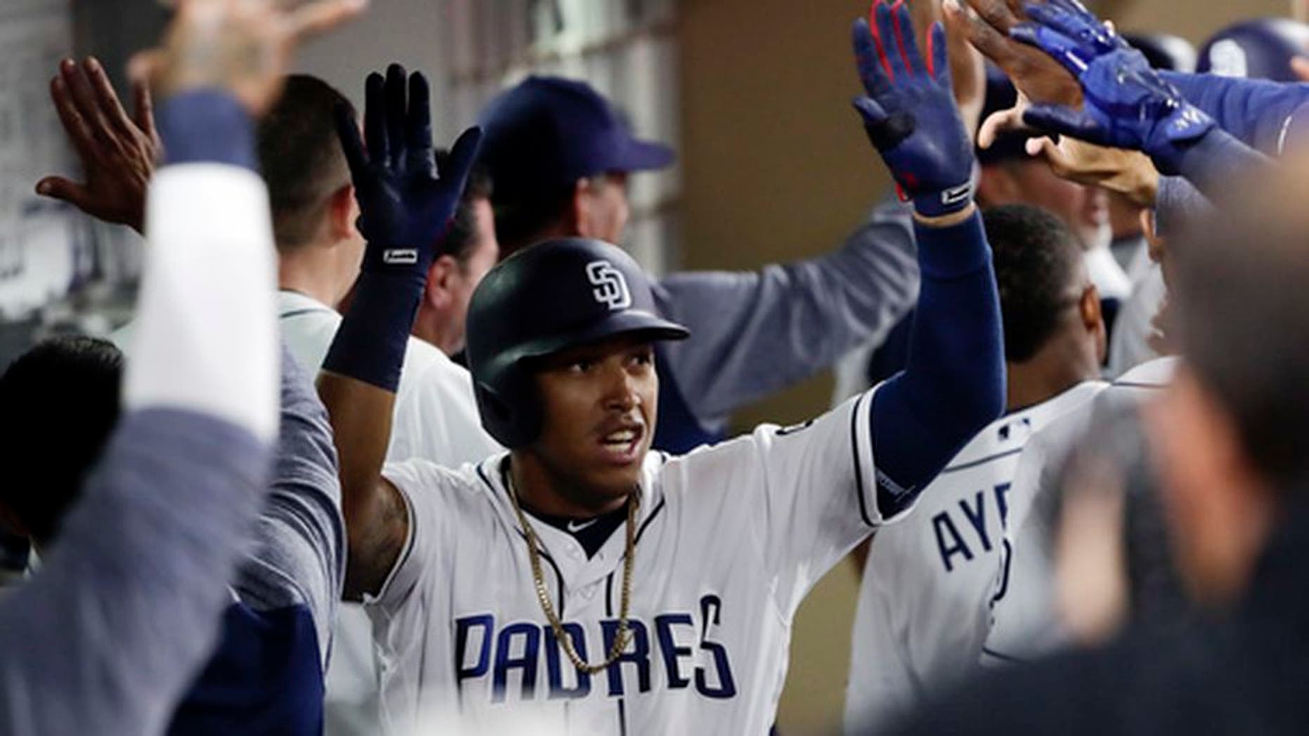 San Diego Padres' Yangervis Solarte is greeted by teammates in the dugout after his two-run home run during the sixth inning of a baseball game against the Colorado Rockies on Tuesday, May 2, 2017, in San Diego. (AP Photo/Gregory Bull)
