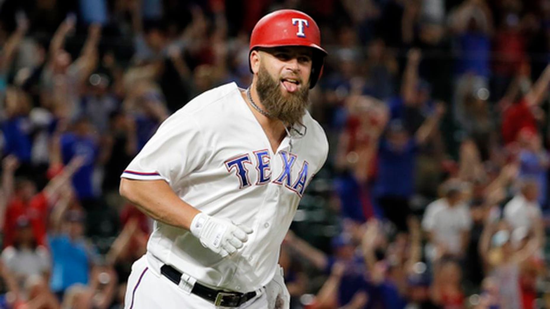 Texas Rangers' Mike Napoli celebrates as he runs the bases after hitting a game-winning three-run home run off San Diego Padres reliever Brandon Maurer during the ninth inning of a baseball game, Thursday, May 11, 2017, in Arlington, Texas. The Rangers won 5-2. (AP Photo/Tony Gutierrez)
