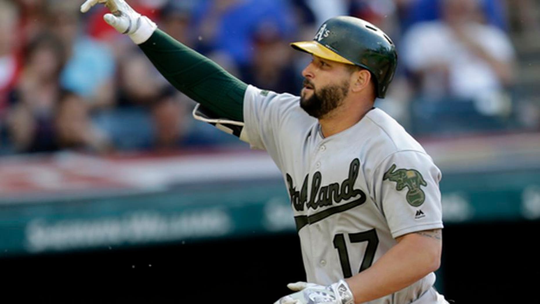Oakland Athletics' Yonder Alonso points after hitting a solo home run off Cleveland Indians starting pitcher Carlos Carrasco in the seventh inning of a baseball game, Monday, May 29, 2017, in Cleveland. (AP Photo/Tony Dejak)