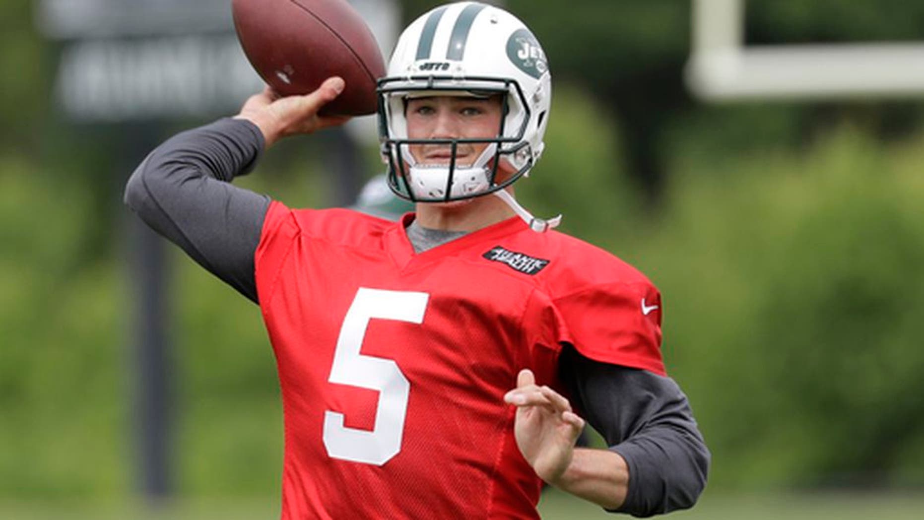 FILE - In this May 23, 2017, file photo, New York Jets' Christian Hackenberg throws a pass during the team's organized team activities at its NFL football training facility in Florham Park, N.J. The Jets would like to see Hackenberg take charge in the team's quarterback competition. But with the 2016 second-round draft pick out of Penn State still considered a project after not playing at all last season, it remains uncertain whether Hackenberg will progress enough to be the starter this year. (AP Photo/Julio Cortez, File)