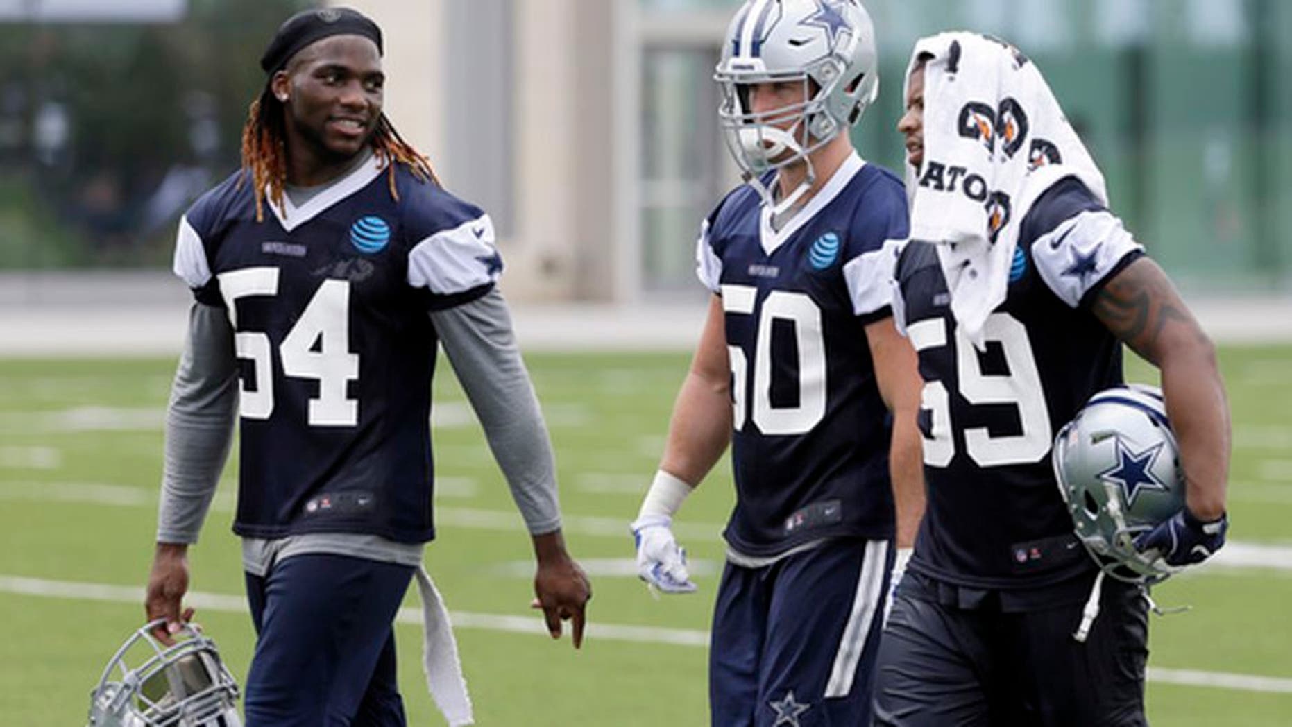 Dallas Cowboys' Jaylon Smith (54), Sean Lee (50) and Anthony Hitchens (59) walk off the practice field after NFL football practice at the team's training facility, Tuesday, June 13, 2017, in Frisco, Texas. Lee is surrounded by uncertainty on a Dallas defense needing improvement to match a dynamic offense that carried the Cowboys to the best record in the NFC last year. The All-Pro linebacker is a pretty good starting point. (AP Photo/Tony Gutierrez)