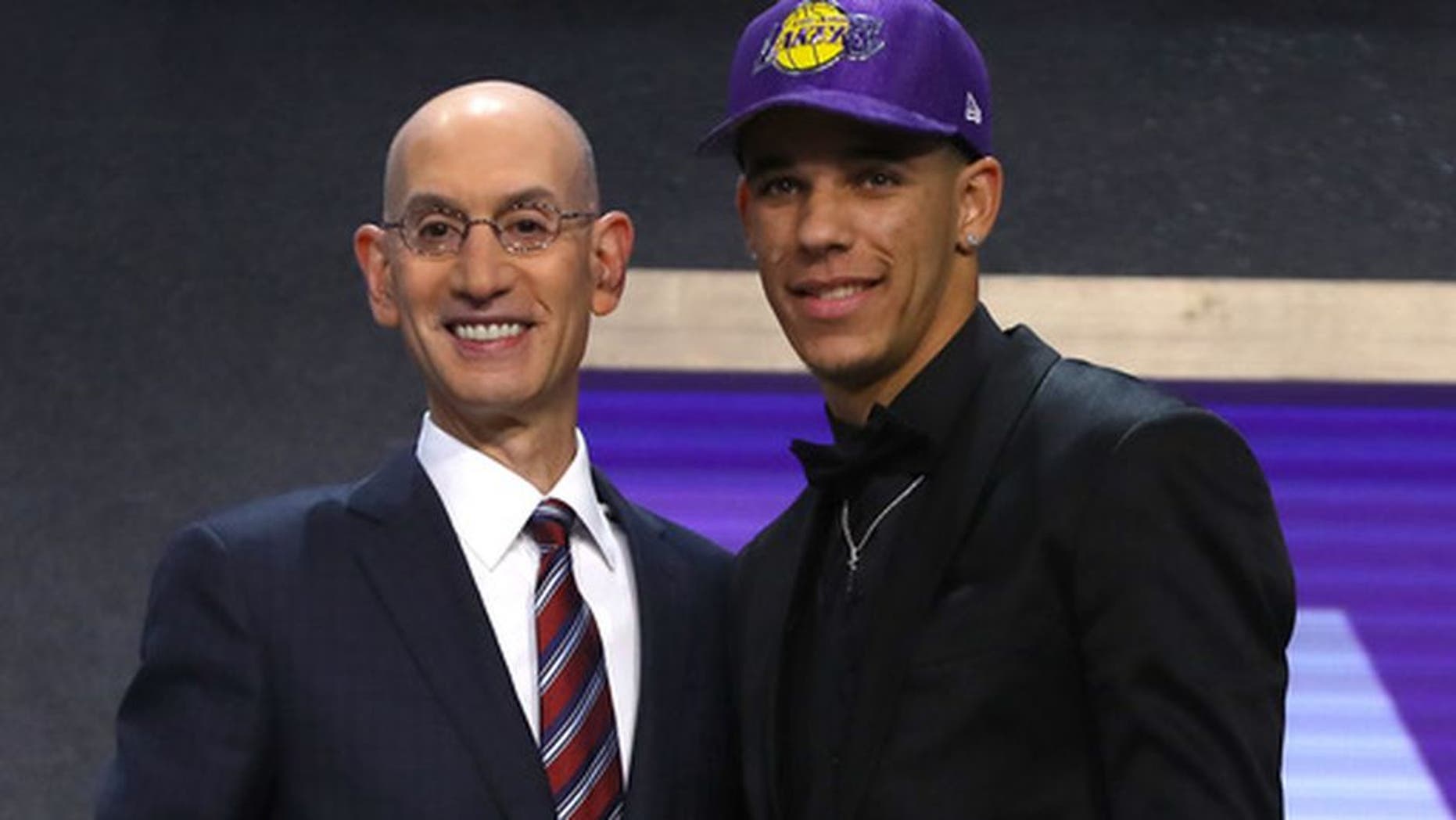 NEW YORK, NY - JUNE 22: Lonzo Ball walks on stage with NBA commissioner Adam Silver after being drafted second overall by the Los Angeles Lakers during the first round of the 2017 NBA Draft at Barclays Center on June 22, 2017 in New York City. NOTE TO USER: User expressly acknowledges and agrees that, by downloading and or using this photograph, User is consenting to the terms and conditions of the Getty Images License Agreement. (Photo by Mike Stobe/Getty Images)