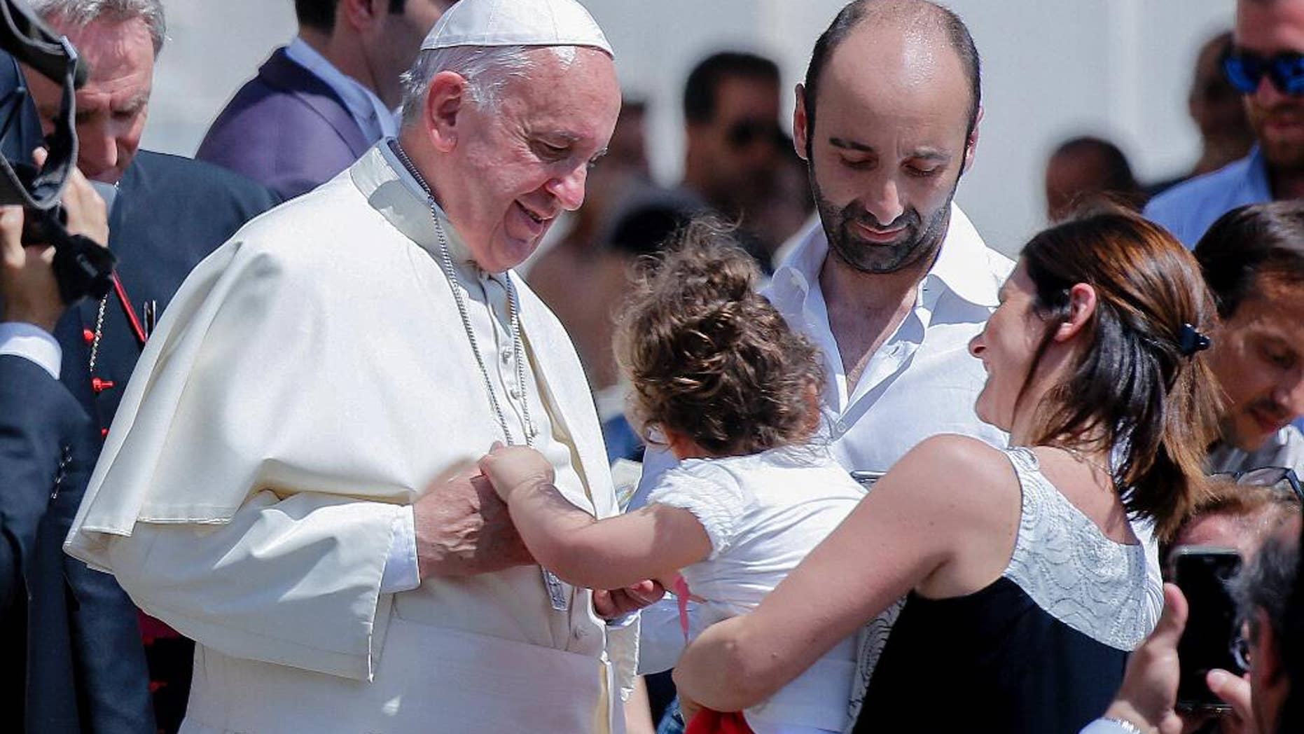 Pope Francis caresses a child at the end of his weekly general audience in St. Peter's Square at the Vatican, Wednesday, June 22, 2016. (AP Photo/Fabio Frustaci)