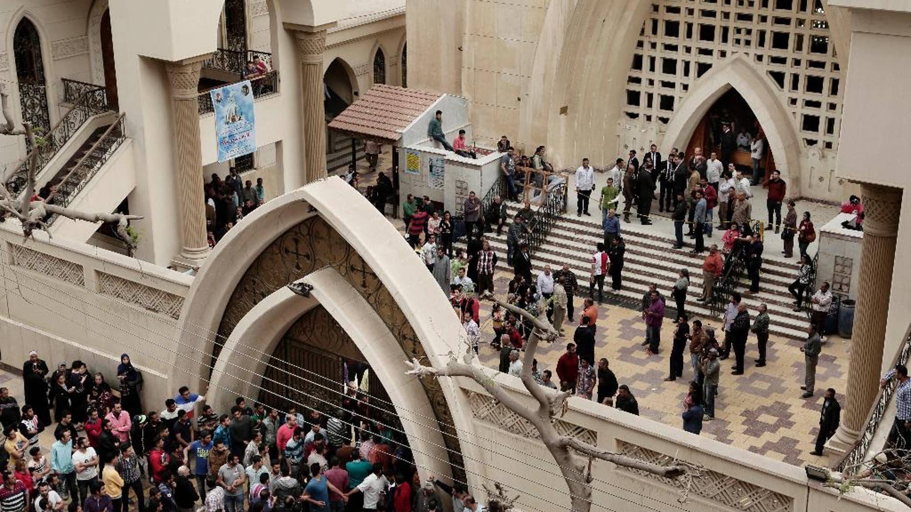 Sunday, April 9, 2017: People gather outside the St. George's Church after a deadly suicide bombing, in the Nile Delta town of Tanta, Egypt.