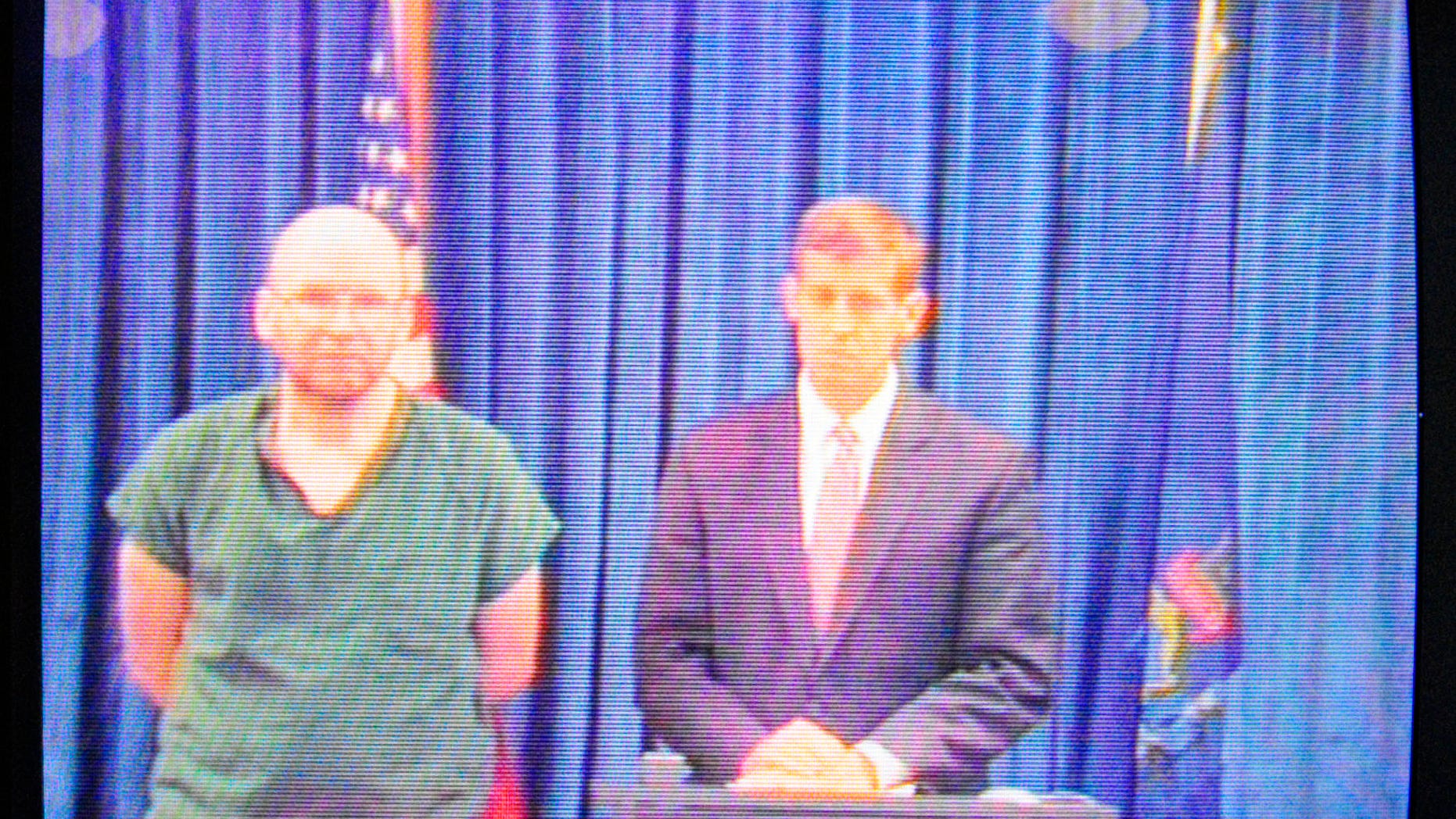 "North Pond Hermit" Christopher Knight, left, and his attorney Walter McKee appear via video conference during a court hearing on new burglary and theft charges on Tuesday April 16, 2013 in Kennebec County Superior Court in Augusta, Maine. Knight and McKee were appearing on video connection from the nearby Kennebec County jail. (AP Photo/Kennebec Journal/Joe Phelan)