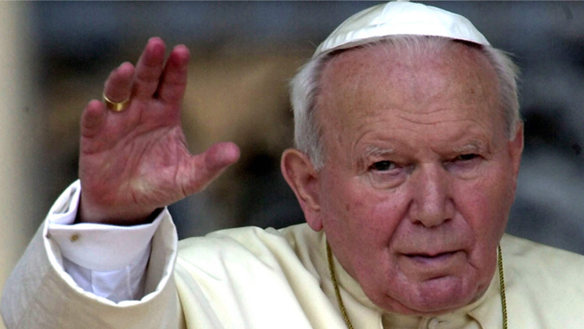 In this May 2, 2001 file photo, Pope John Paul II waves to faithfuls gathered for the weekly general audience at St. Peter's Square in the Vatican.