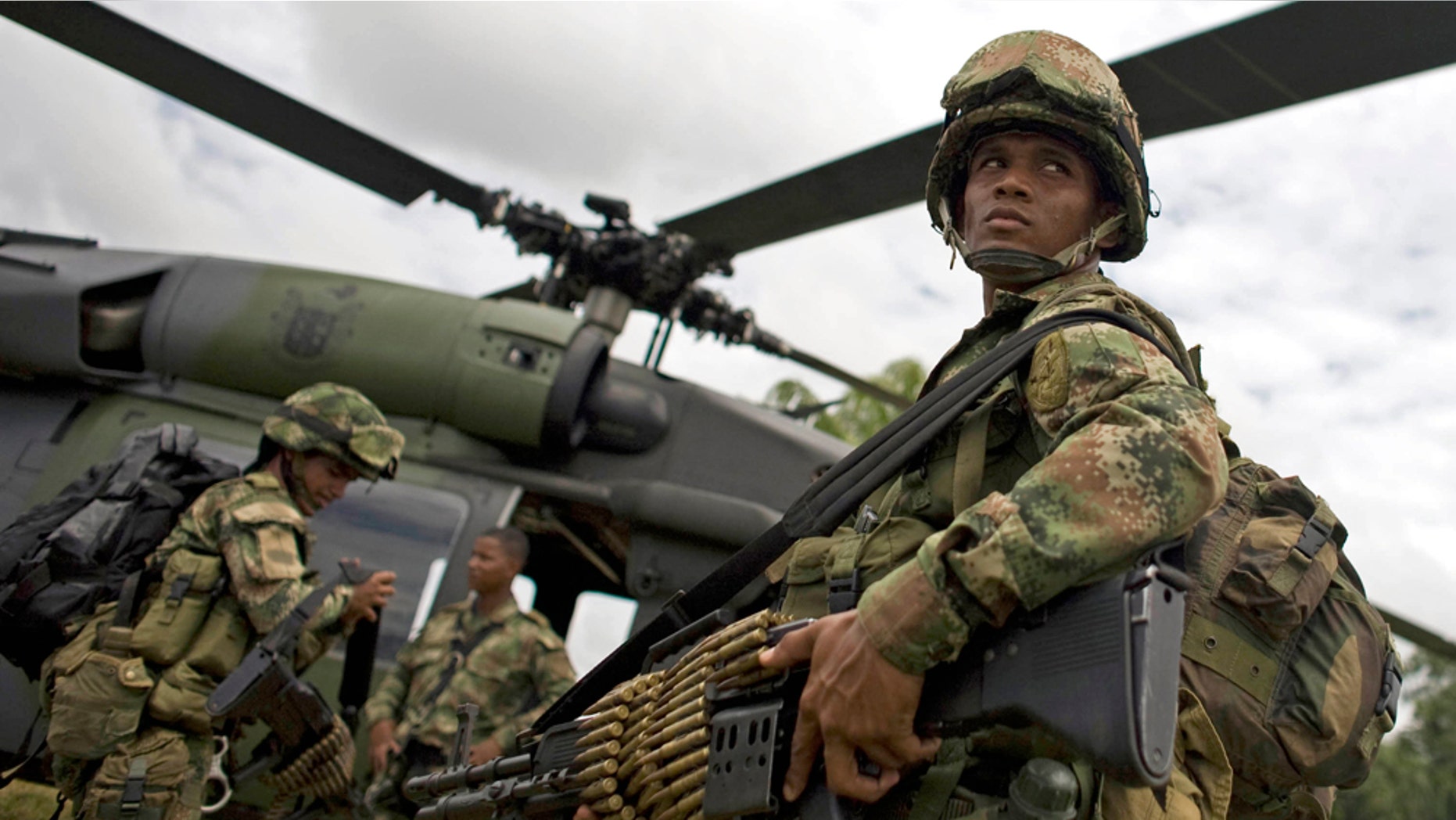 Soldiers board a helicopter in Guerima, in the eastern province of Vichada, Colombia, Wednesday March 9, 2011. (AP Photo/William Fernando Martinez)