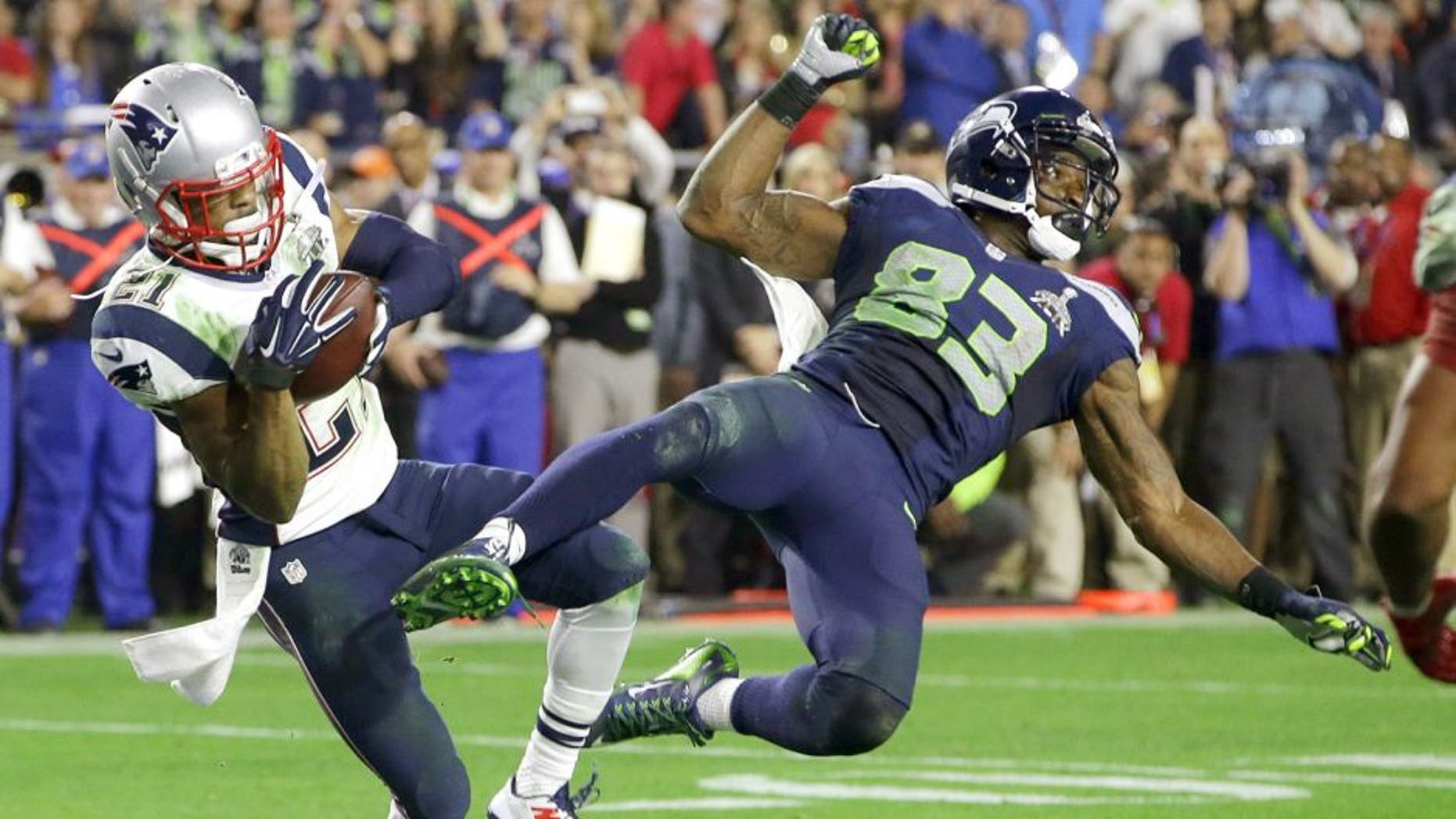 New England Patriots strong safety Malcolm Butler (21) intercepts a pass intended for Seattle Seahawks wide receiver Ricardo Lockette (83) during the second half of NFL Super Bowl XLIX football game Sunday, Feb. 1, 2015, in Glendale, Ariz. (AP Photo/Kathy Willens)
