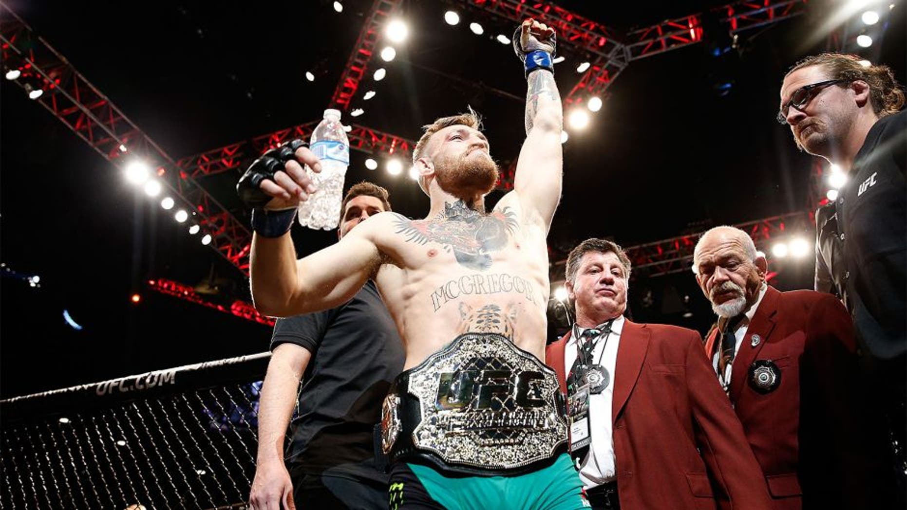LAS VEGAS, NV - DECEMBER 12: Conor McGregor of Ireland exits the Octagon after his victory over Jose Aldo of Brazil in their UFC featherweight championship bout during the UFC 194 event inside MGM Grand Garden Arena on December 12, 2015 in Las Vegas, Nevada. (Photo by Christian Petersen/Zuffa LLC/Zuffa LLC via Getty Images)