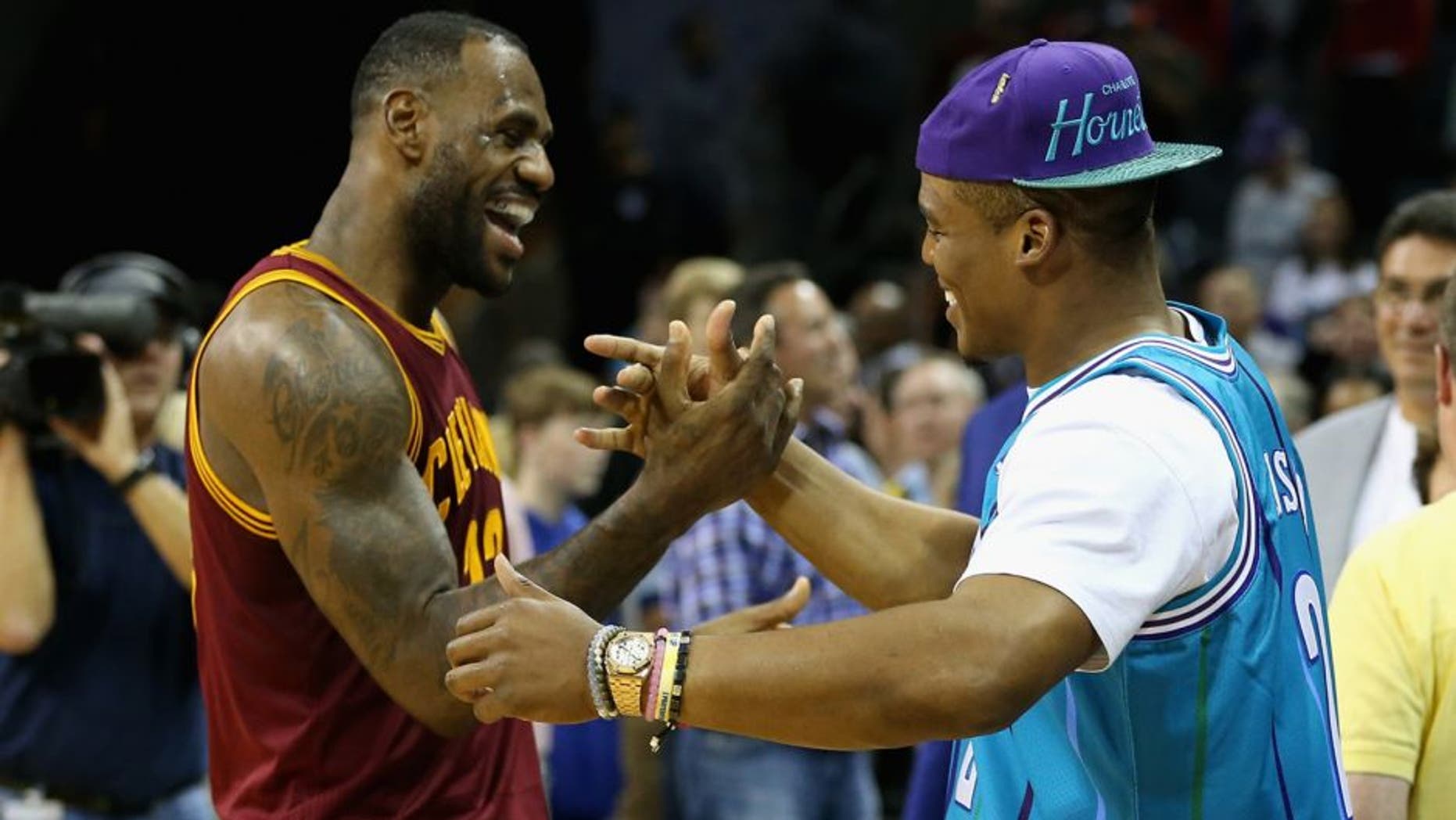 CHARLOTTE, NC - NOVEMBER 27: (L-R) LeBron James #23 of the Cleveland Cavaliers talks to Cam Newton, quarterback of the Carolina Panthers after the Cavaliers defeated the Hornets 95-90 at Time Warner Cable Arena on November 27, 2015 in Charlotte, North Carolina. NBA - NOTE TO USER: User expressly acknowledges and agrees that, by downloading and or using this photograph, User is consenting to the terms and conditions of the Getty Images License Agreement. (Photo by Streeter Lecka/Getty Images)