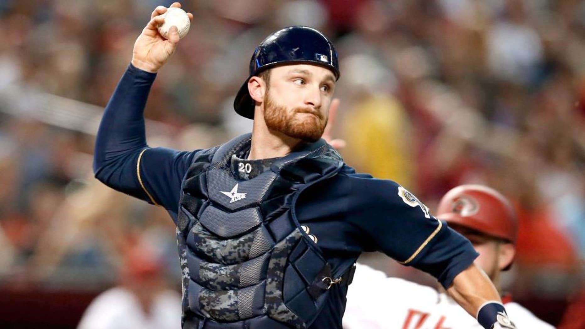 Jul 24, 2015; Phoenix, AZ, USA; Milwaukee Brewers catcher Jonathan Lucroy (20) turns the double play while avoiding Arizona Diamondbacks right fielder Ender Inciarte (5) in the third inning at Chase Field. Mandatory Credit: Rick Scuteri-USA TODAY Sports