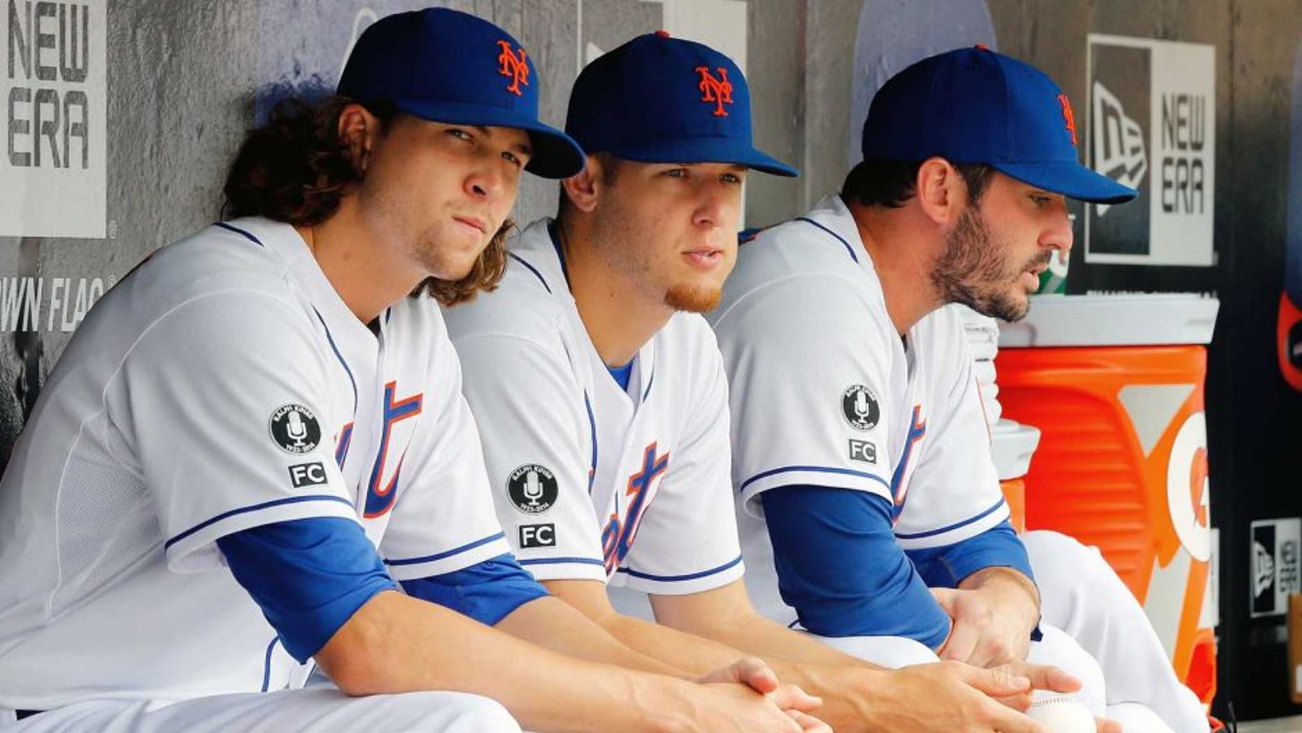 NEW YORK, NY - AUGUST 03: (L-R) Jacob deGrom #48, Zack Wheeler #45 and Matt Harvey #33 of the New York Mets look on against the San Francisco Giants at Citi Field on August 3, 2014 in the Flushing neighborhood of the Queens borough of New York City. The Giants defeated the Mets 9-0. (Photo by Jim McIsaac/Getty Images)