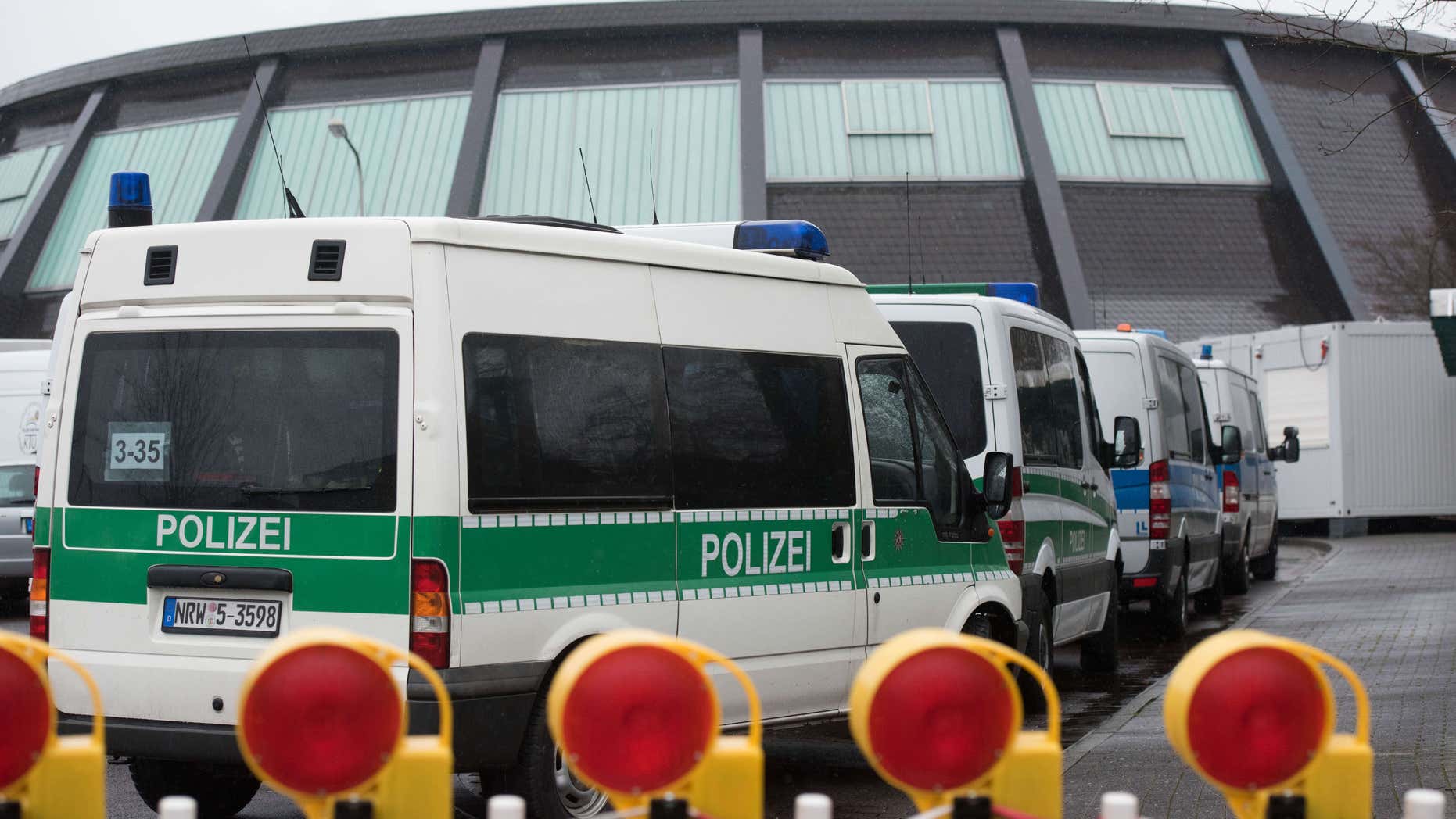 Feb. 4, 2016: Police vehicles park in front of the reception facility for refugees located in a gymnasium in Attendorn, Germany.