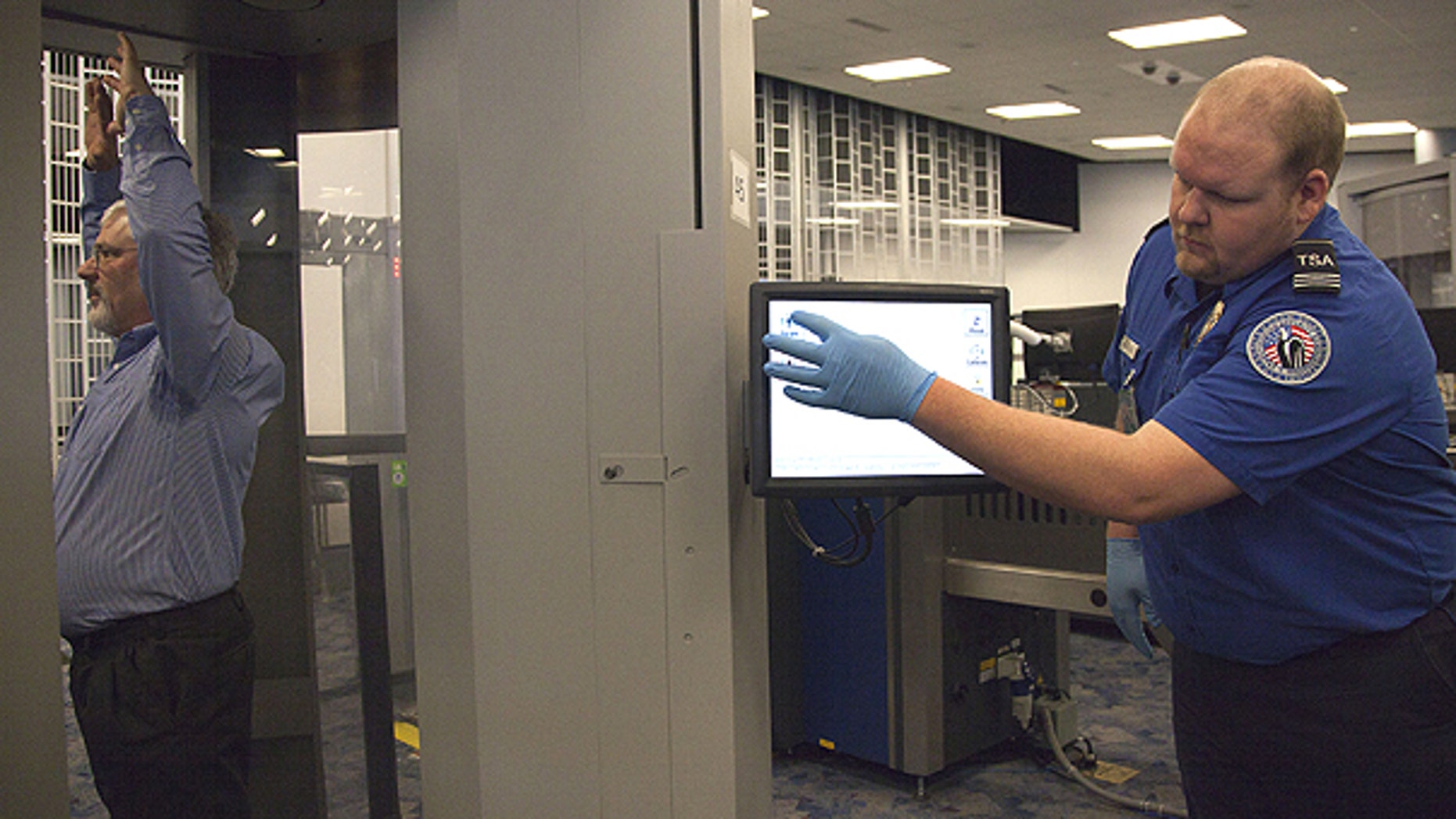 Feb. 1: Transportation Security Administration supervisor Nick Fox, right, demonstrates new software being tested with advanced imaging technology at McCarran International Airport in Las Vegas.