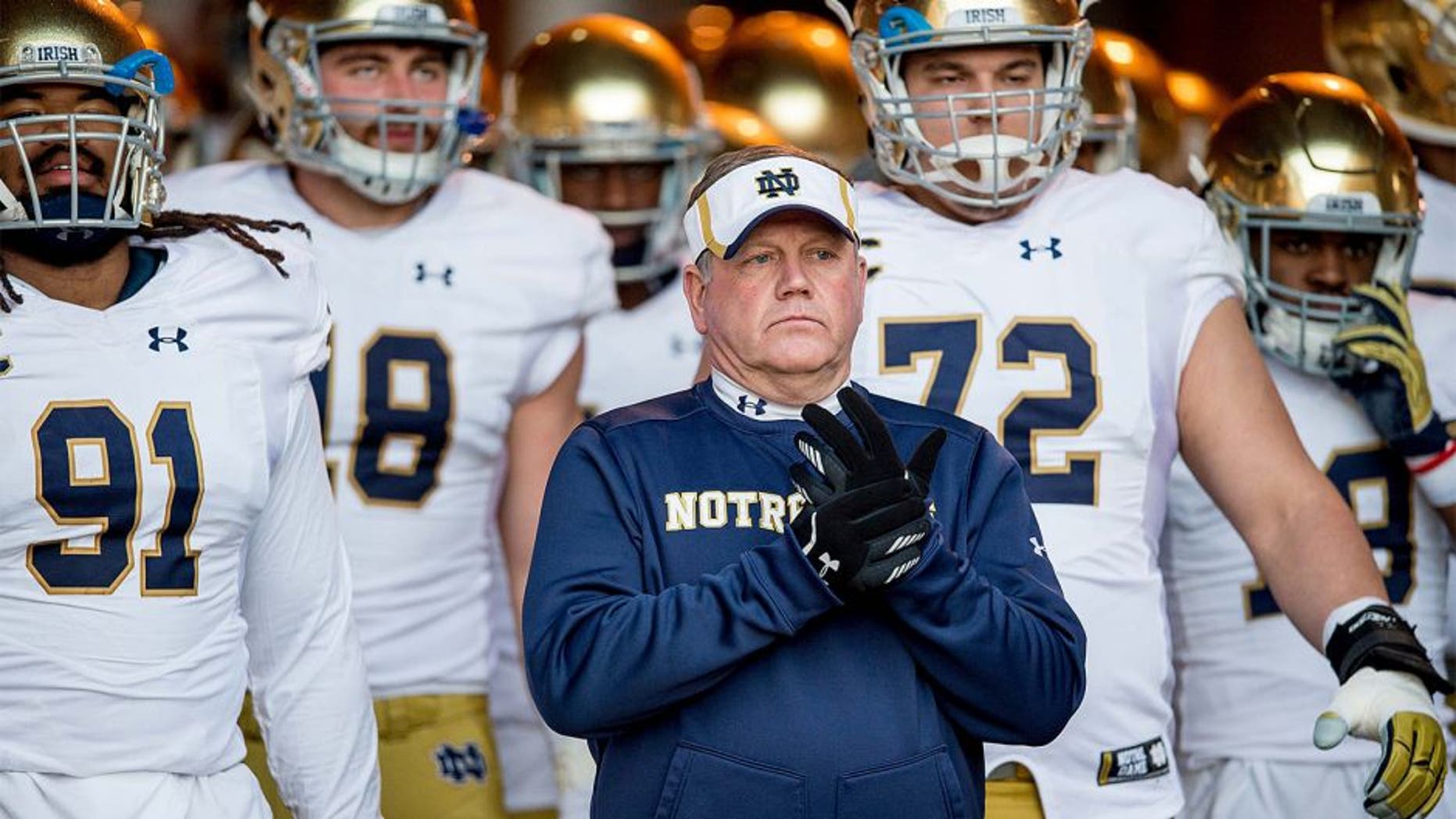 Nov 28, 2015; Stanford, CA, USA; Notre Dame Fighting Irish head coach Brian Kelly leads his team onto the field against the Stanford Cardinal at Stanford Stadium. Stanford won 38-36.Mandatory Credit: Matt Cashore-USA TODAY Sports
