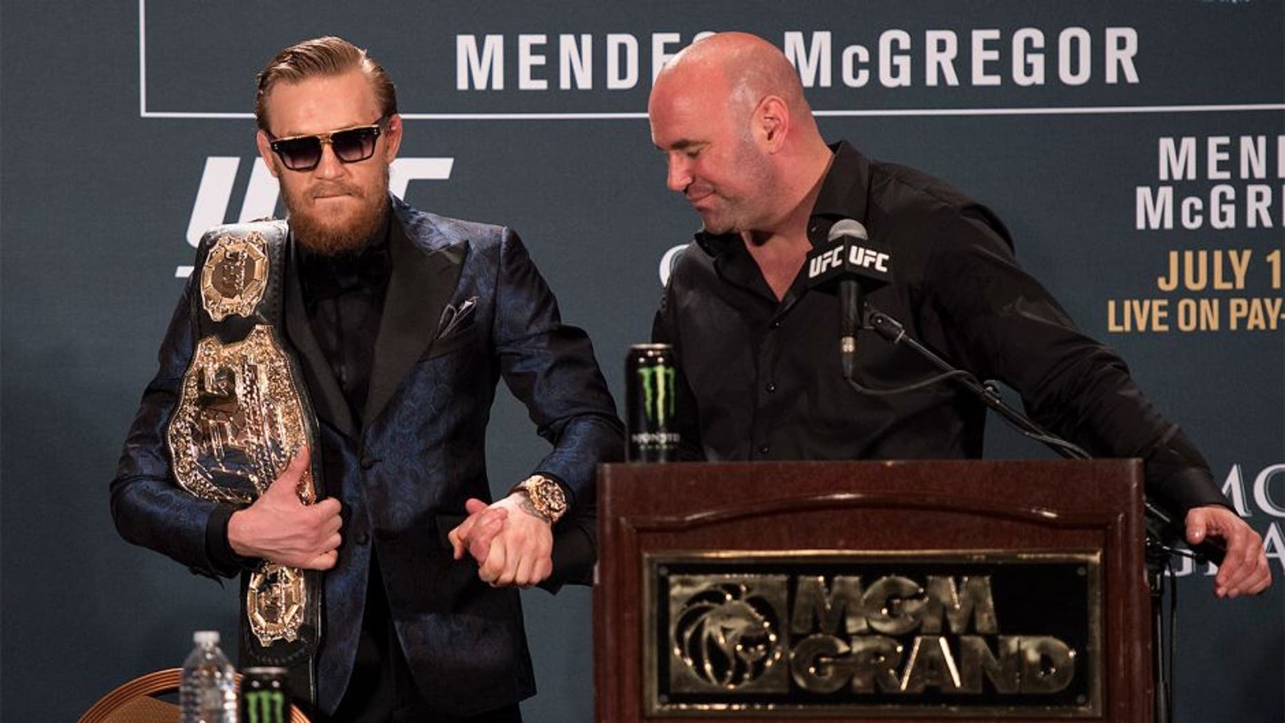 LAS VEGAS, NV - JULY 11: UFC President Dana White (R) greets UFC interim featherweight champion Conor McGregor during the UFC 189 post fight press conference at the MGM Grand Garden Arena on July 11, 2015 in Las Vegas, Nevada. (Photo by Jeff Bottari/Zuffa LLC/Zuffa LLC via Getty Images)