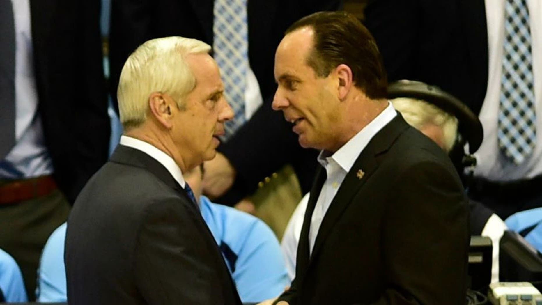 Jan 5, 2015; Chapel Hill, NC, USA; North Carolina Tar Heels head coach Roy Williams and Notre Dame Fighting Irish head coach Mike Brey greet each other before the game at Dean E. Smith Center. Mandatory Credit: Bob Donnan-USA TODAY Sports