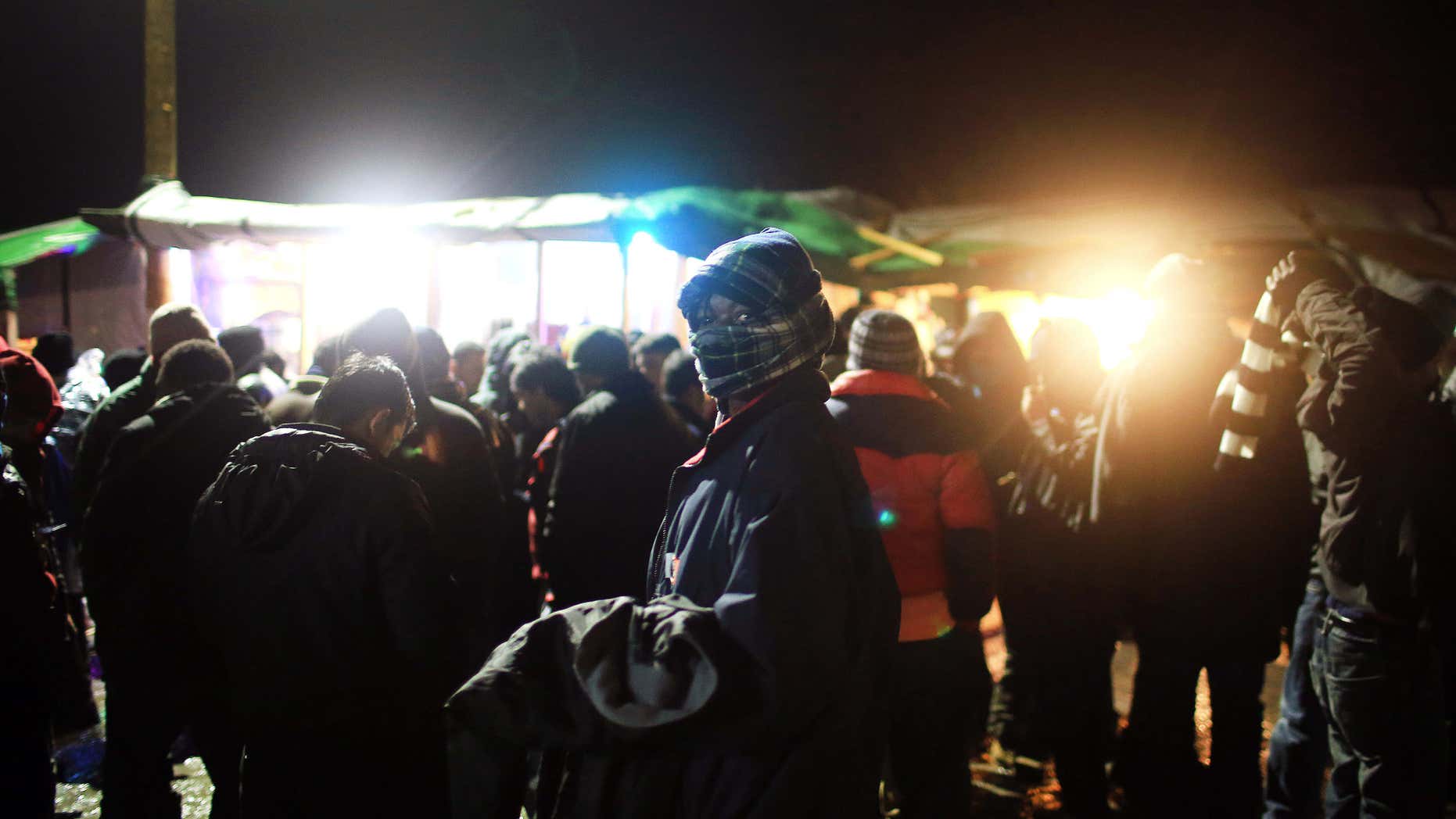 Feb. 4, 2016: A migrant sells clothes in the migrant camp of Calais, northern France.