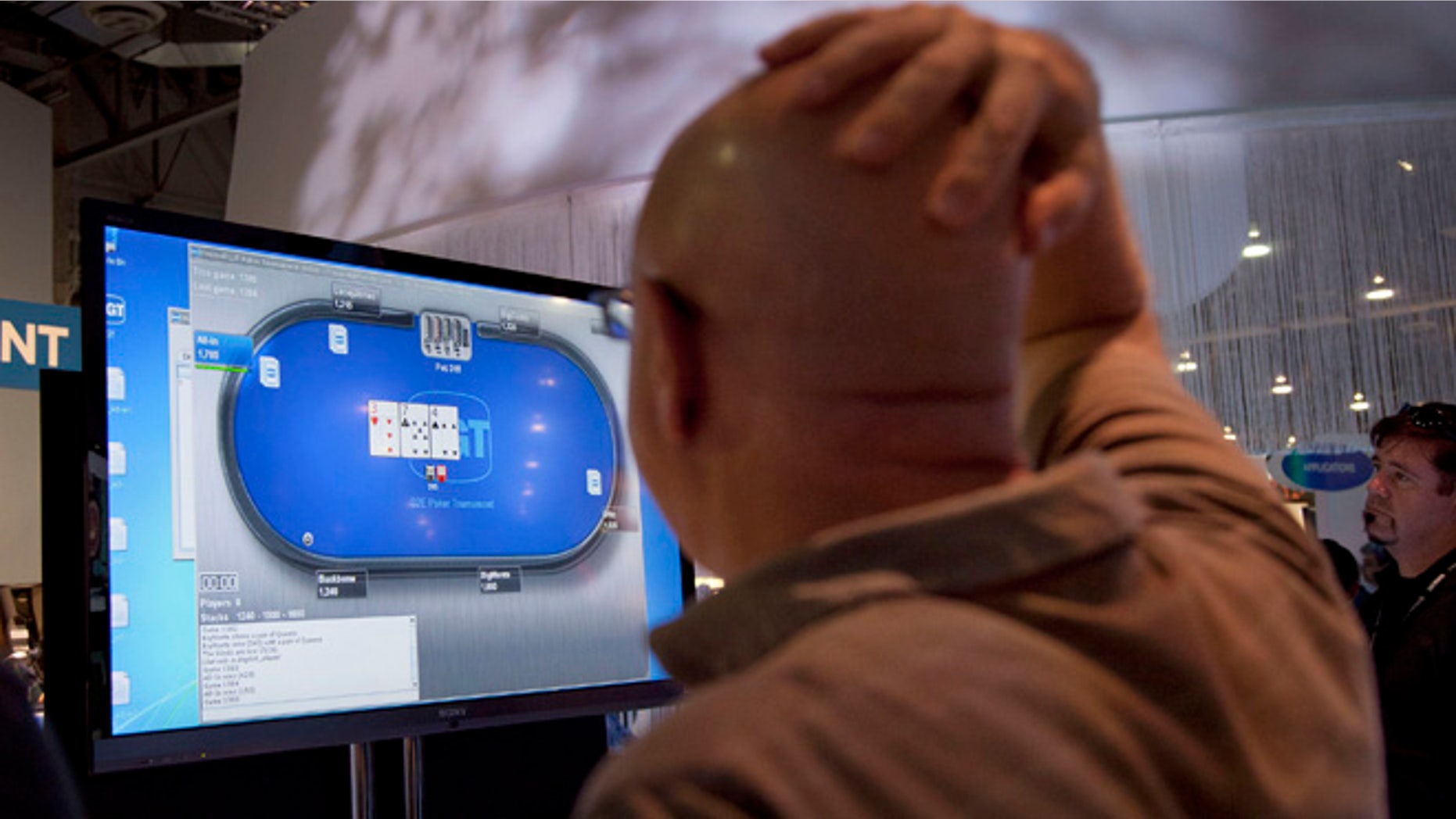 FILE - This Oct. 4, 2011 file photo shows an online poker player playing a game during industry's G2E conference in Las Vegas.