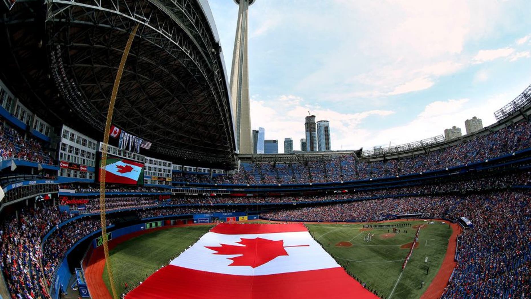 TORONTO, CANADA - JULY 1: A general view of the Rogers Centre on Canada Day as a large Canadian flag is unfurled on the field during the singing of the Canadian anthem before the start of the Toronto Blue Jays MLB game against the Milwaukee Brewers on July 1, 2014 at Rogers Centre in Toronto, Ontario, Canada. (Photo by Tom Szczerbowski/Getty Images)