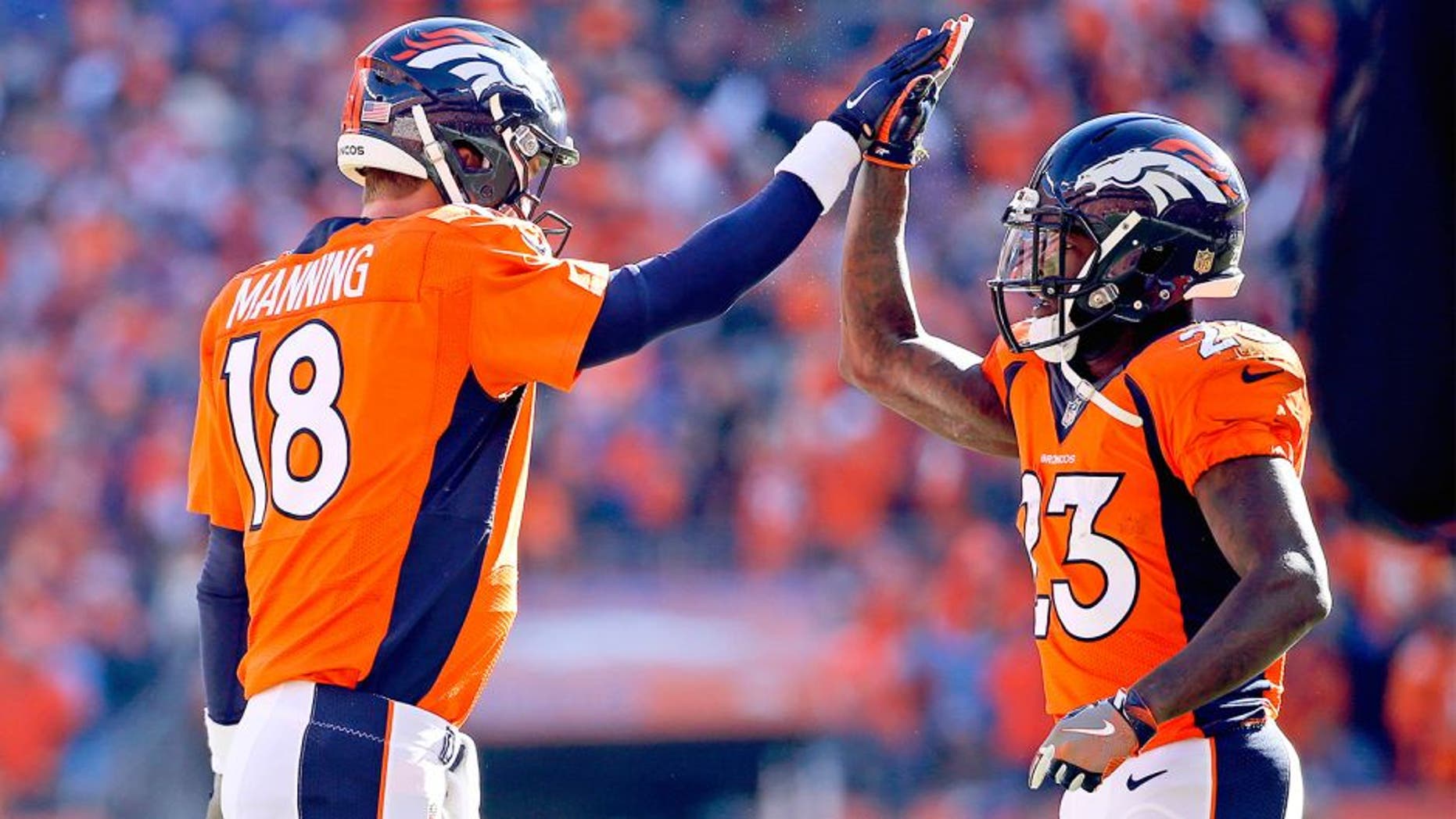 Jan 24, 2016; Denver, CO, USA; Denver Broncos quarterback Peyton Manning (18) celebrates with running back Ronnie Hillman (23) during the game against the New England Patriots in the AFC Championship football game at Sports Authority Field at Mile High. Mandatory Credit: Kevin Jairaj-USA TODAY Sports