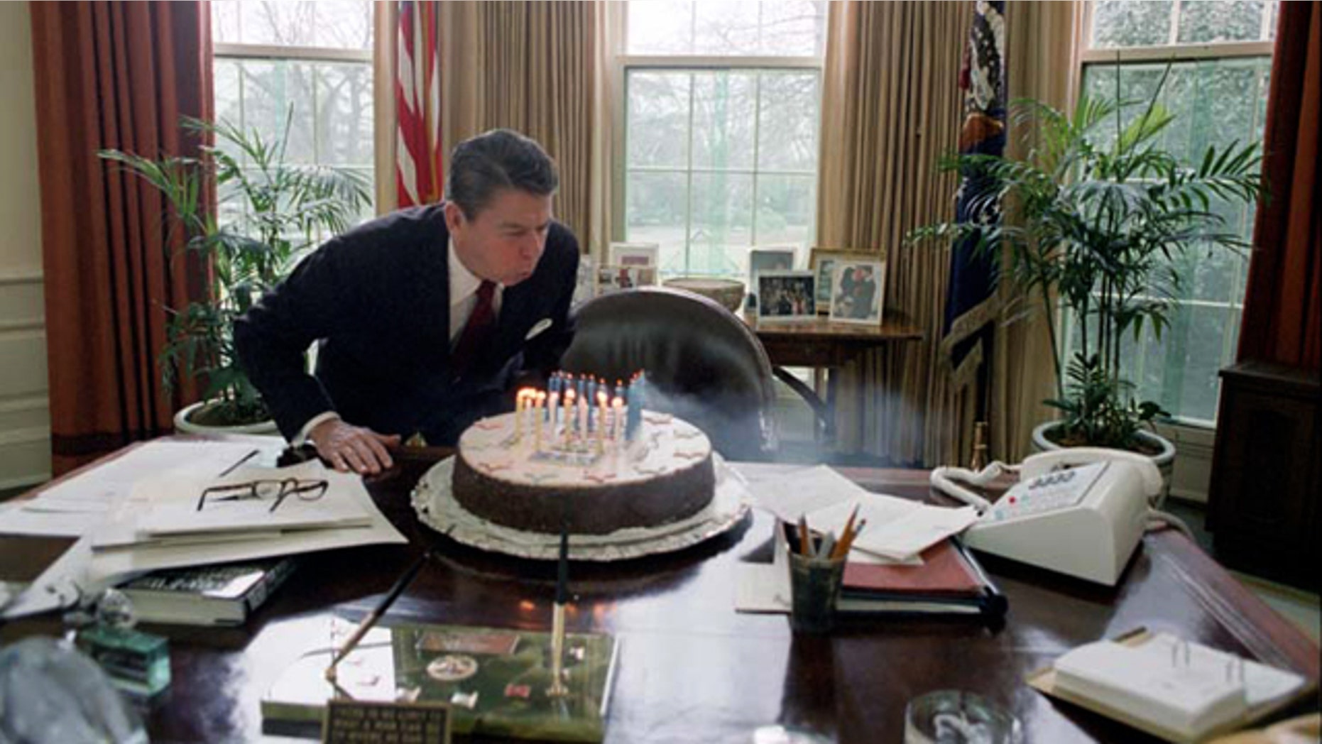 Feb. 5, 1982: President Reagan blows out candles on his birthday cake in the Oval Office.