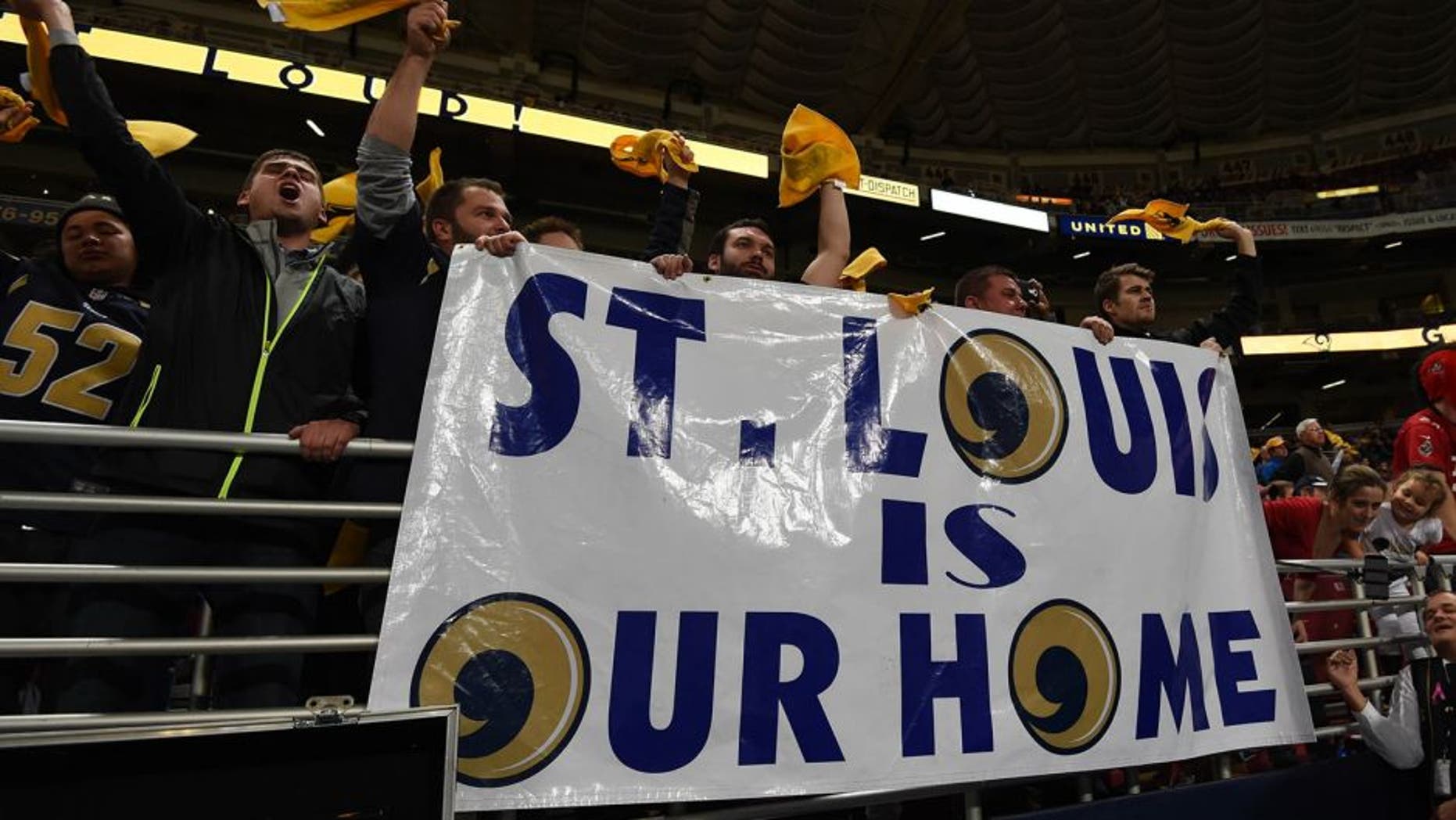 Dec 17, 2015; St. Louis, MO, USA; St. Louis Rams fans hold banner that reads "St. Louis is our home" in reference to the team's proposed relocation to Los Angeles during an NFL football game against the Tampa Bay Buccaneers at the Edward Jones Dome. Mandatory Credit: Kirby Lee-USA TODAY Sports