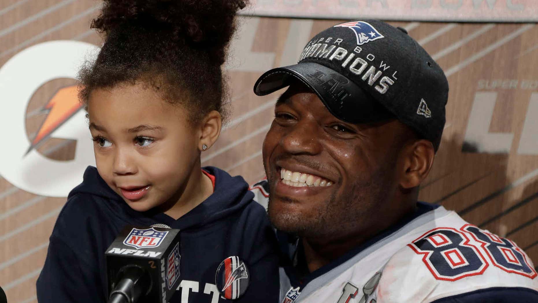 New England Patriots' Martellus Bennett appears at a news conference with his daughter Austyn Jett Rose Bennett after the NFL Super Bowl 51 football game Sunday, Feb. 5, 2017, in Houston.