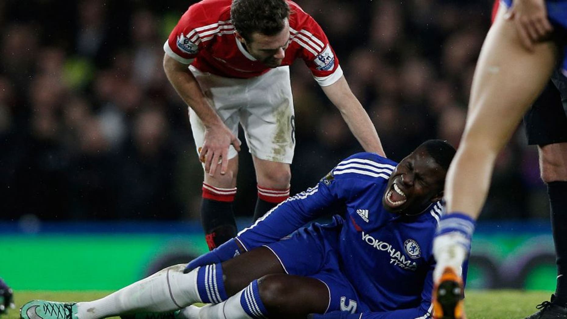 Chelsea's French defender Kurt Zouma clutches his knee during the English Premier League football match between Chelsea and Manchester United at Stamford Bridge in London on February 7, 2016. / AFP / ADRIAN DENNIS / RESTRICTED TO EDITORIAL USE. No use with unauthorized audio, video, data, fixture lists, club/league logos or 'live' services. Online in-match use limited to 75 images, no video emulation. No use in betting, games or single club/league/player publications. / (Photo credit should read ADRIAN DENNIS/AFP/Getty Images)