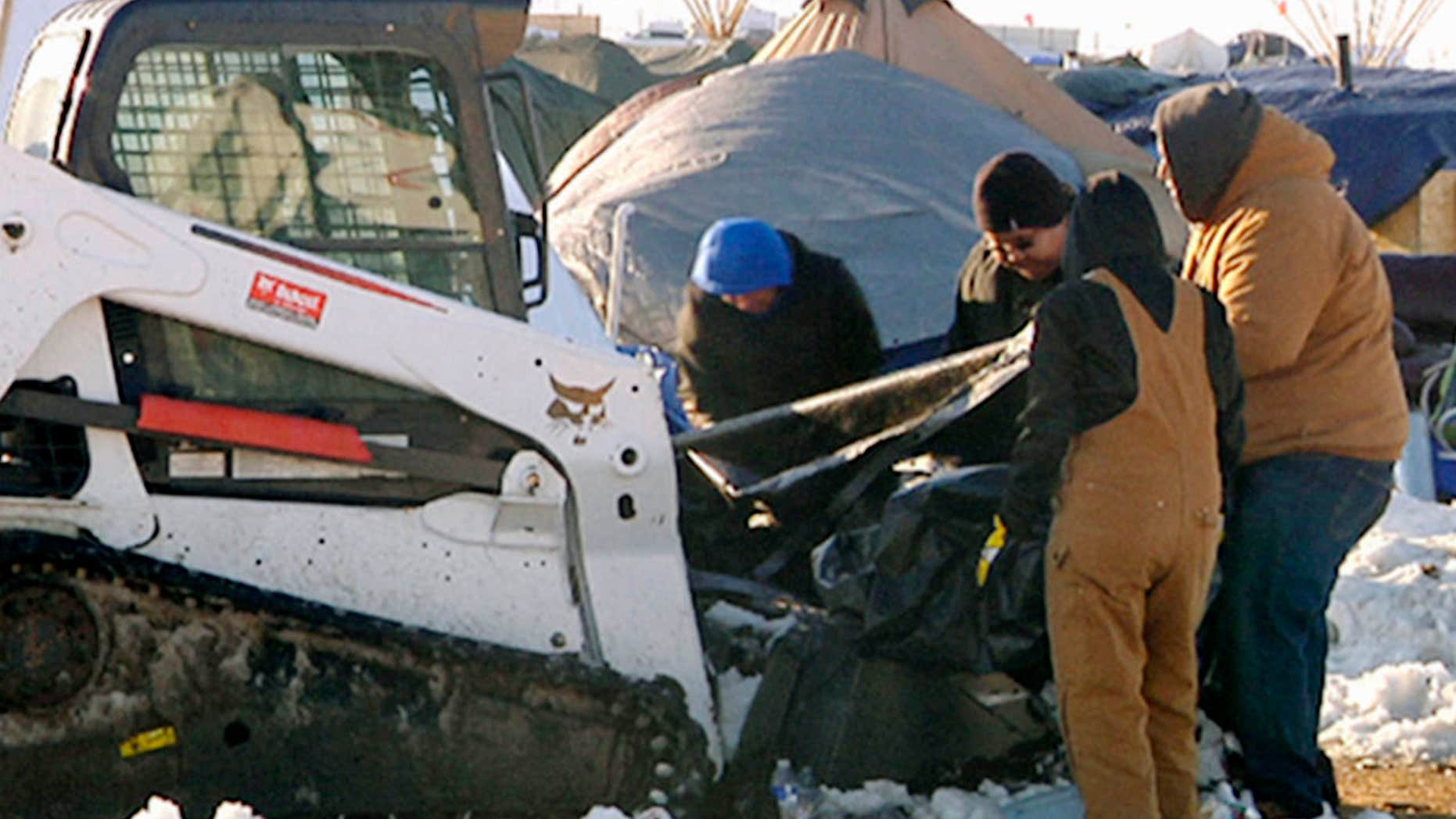 This Monday, Jan. 30, 2017, photo from video provided by KXMB in Bismarck, N.D., shows cleanup beginning at a North Dakota encampment near Cannon Ball where Dakota Access oil pipeline opponents have protested for months.