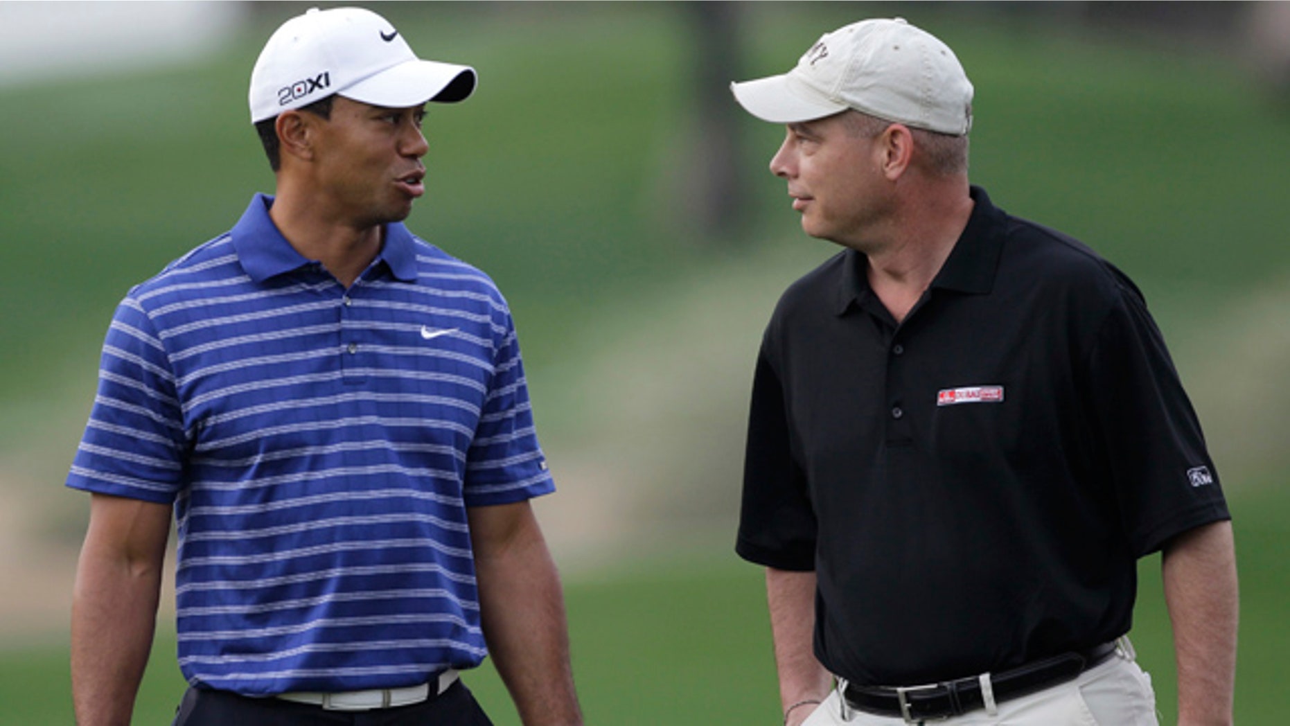 Feb. 9: American Army officer Lt. Col. Micheal Rowells, right, talks with Tiger Woods during the Pro-Am at the Emirates Golf Club a day ahead of Dubai Desert Classic golf tournament in Dubai, United Arab Emirates.