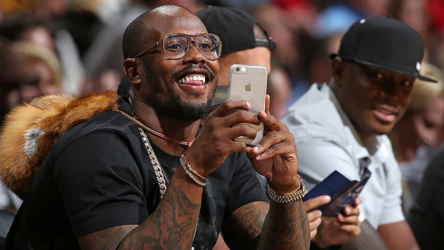 DENVER, CO - NOVEMBER 13: Von Miller of the Denver Broncos uses his iPhone as he watches from courtside as the Houston Rockets face the Denver Nuggets at Pepsi Center on November 13, 2015 in Denver, Colorado. The Nuggets defeated the Rockets 107-98. NOTE TO USER: User expressly acknowledges and agrees that, by downloading and or using this photograph, User is consenting to the terms and conditions of the Getty Images License Agreement. (Photo by Doug Pensinger/Getty Images)