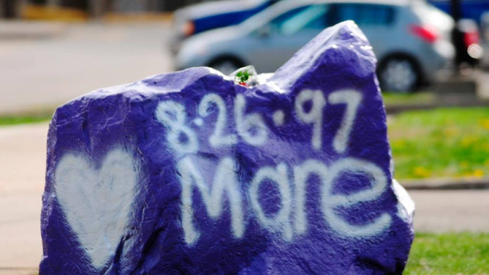 A rock spray-painted by students sits in memory of 16-year-old stabbing victim Maren Sanchez on Friday, April 25, 2014, sits outside Jonathan Law High School in Milford, Conn. Sanchez was stabbed to death earlier during an altercation inside the school. A teenage boy is in custody, and police are investigating whether she was stabbed because she declined to be his date at the junior prom. (AP Photo/The New Haven Register, Peter Hvizdak) MANDATORY CREDIT