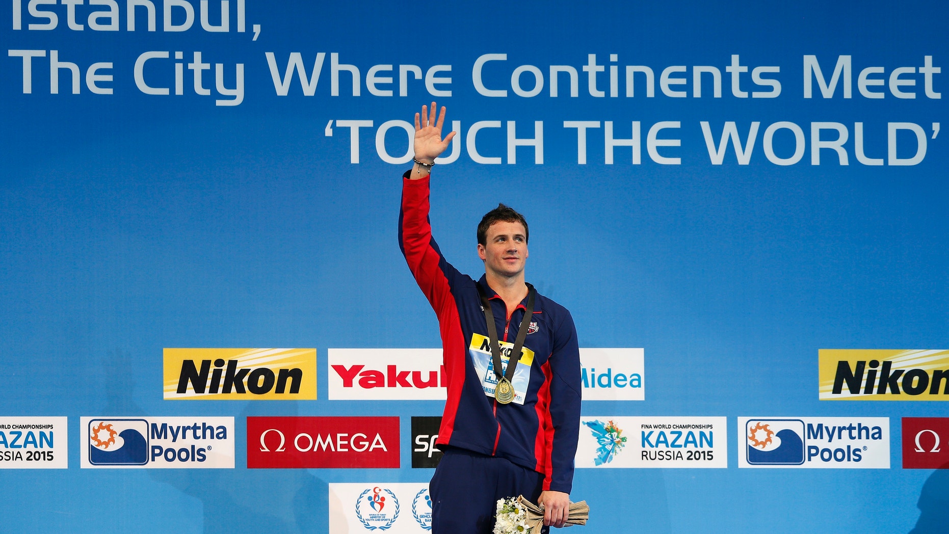 Gold medallist Ryan Lochte of the U.S. celebrates during the award ceremony for the men's 200m individual medley final during the FINA World Swimming Championships in Istanbul December 14, 2012.