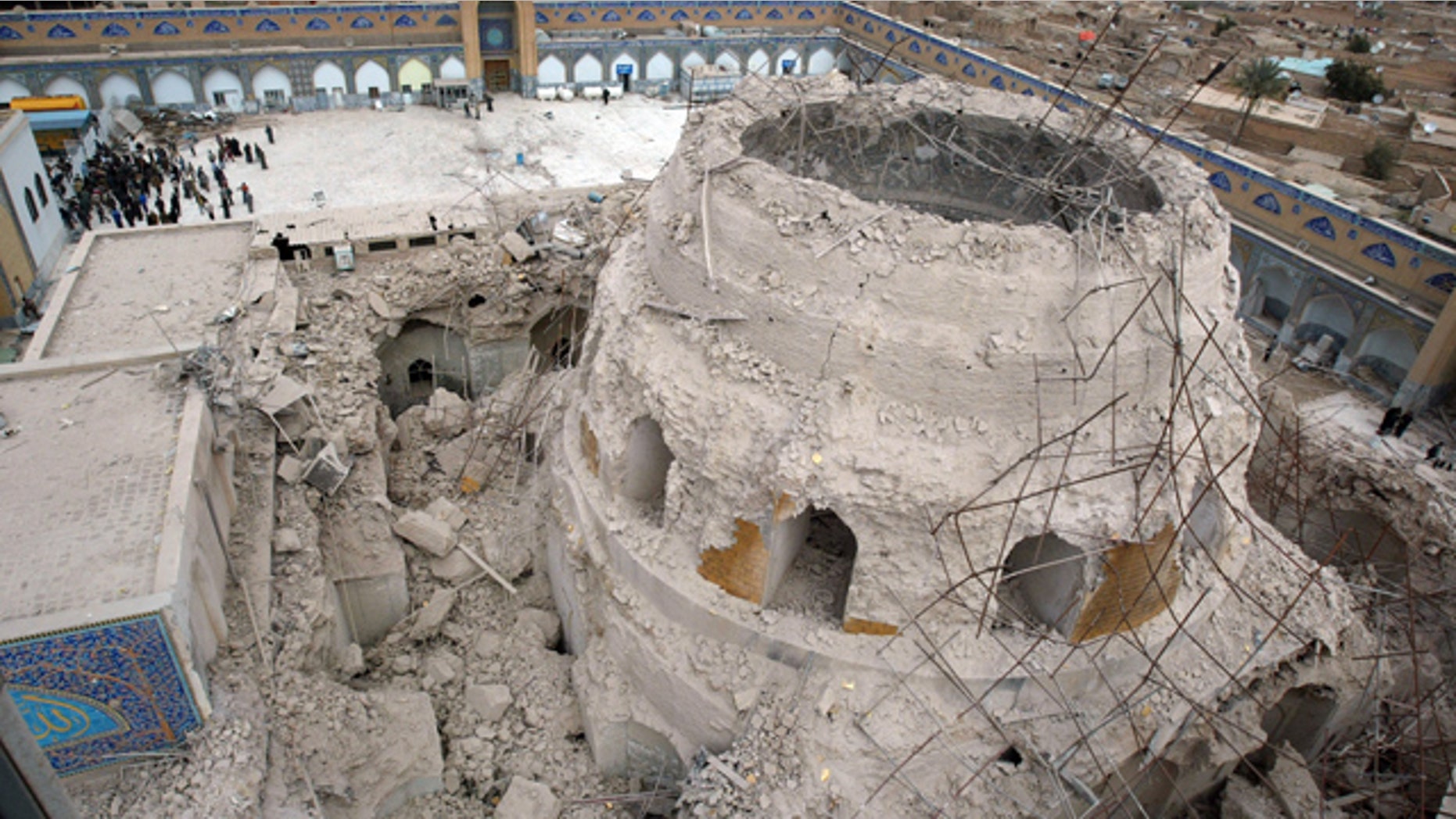 FILE - In this Feb. 22, 2006 file photo, Iraqis gather at the ruins of the al-Askari mosque in Samarra, Iraq.