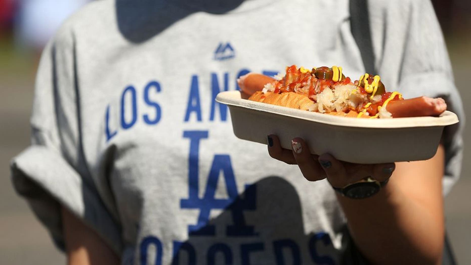 SYDNEY, AUSTRALIA - MARCH 23: A Dodgers fan carries a hot dog prior to the MLB match between the Los Angeles Dodgers and the Arizona Diamondbacks at Sydney Cricket Ground on March 23, 2014 in Sydney, Australia. (Photo by Mark Metcalfe/MLB Photos via Getty Images)