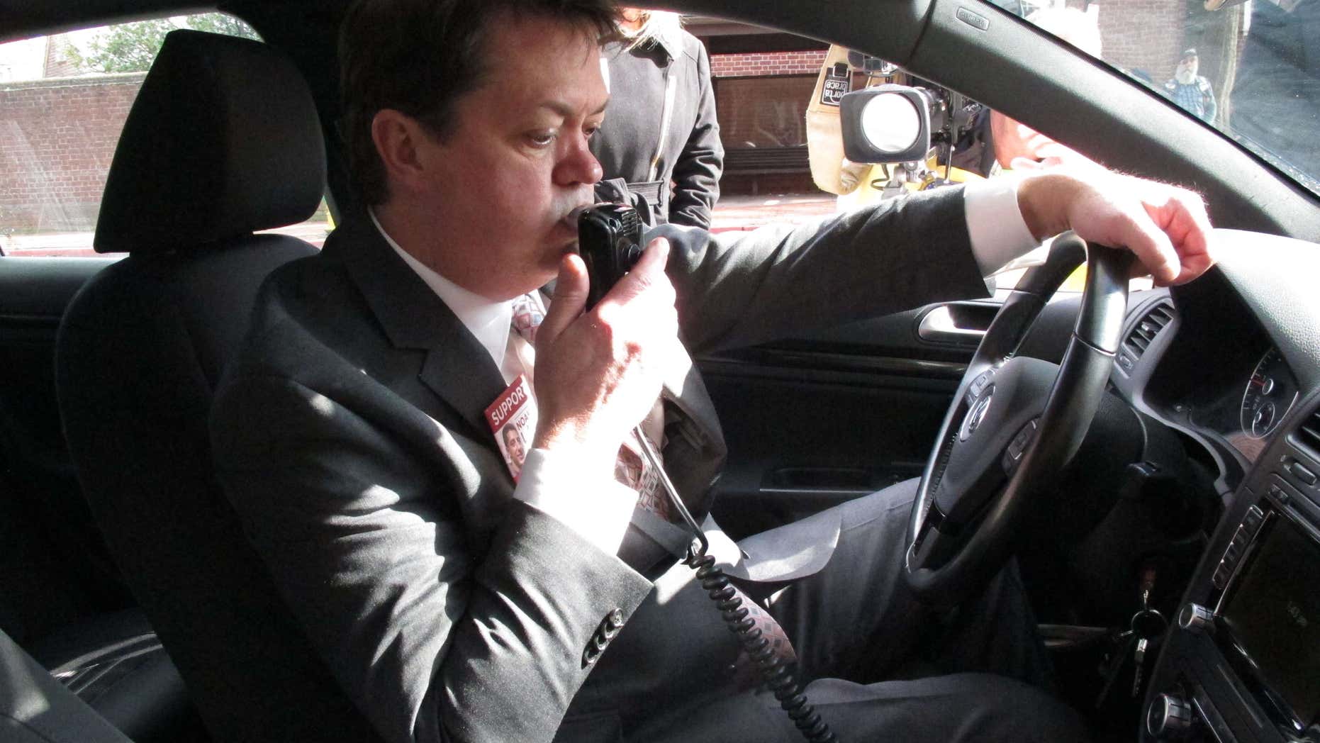 Andrew Wisniewski, an operations manager for Smart Start of Maryland, demonstrates how an ignition interlock device works on Wednesday, Feb. 10, 2016 in Annapolis, Maryland.