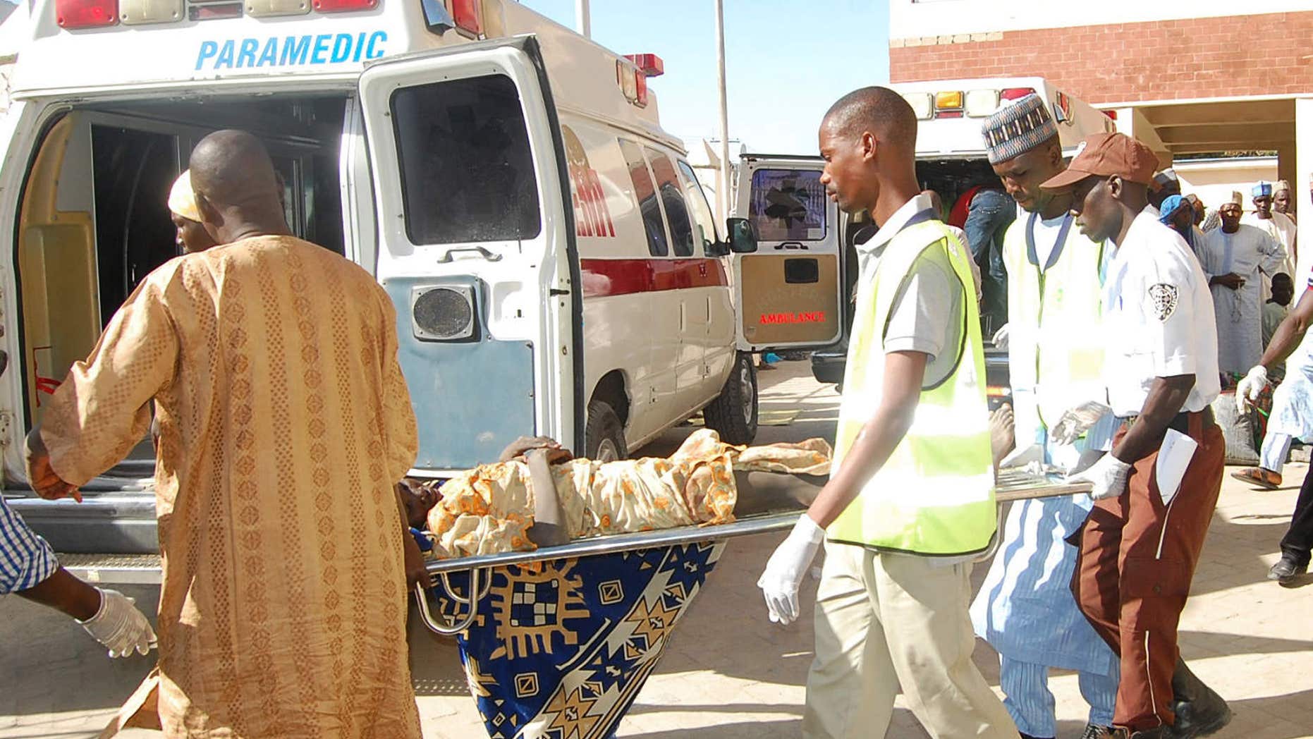 Feb. 10, 2016: Rescue workers transport a victim of a suicide bomb attack at a refugee for treatment at a hospital, in Maiduguri, Nigeria,.