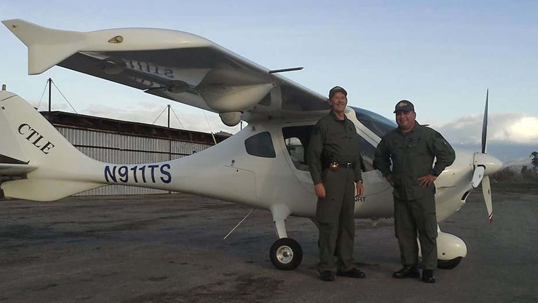 Photo shows Deputy Scott Ballantyne, left, and pilot James Chavez in front of the Tulare County Sheriff's Office plane.
