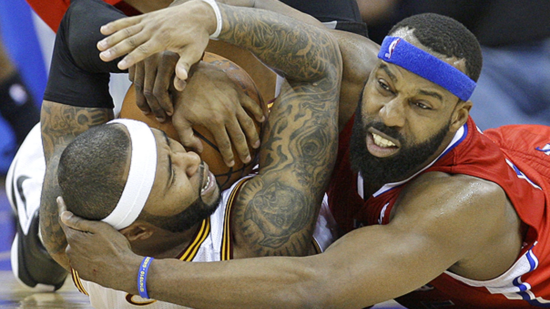 Feb. 11: Cleveland Cavaliers' Mo Williams, left, holds onto the basketball as Los Angeles Clippers' Baron Davis, right, tries to pry it loose in overtime in an NBA game in Cleveland.