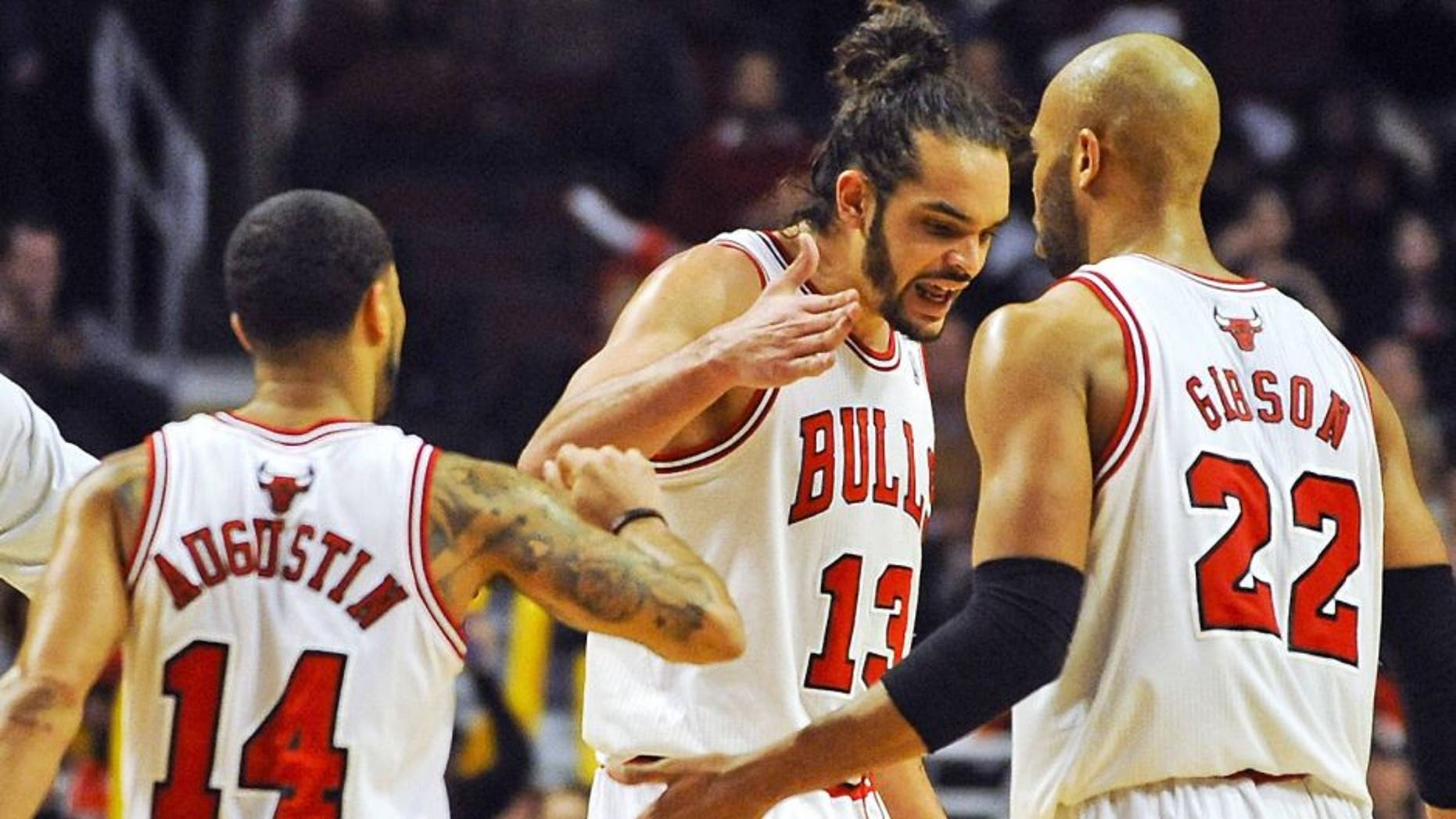 Feb 11, 2014; Chicago, IL, USA; Chicago Bulls point guard D.J. Augustin (14), Chicago Bulls center Joakim Noah (13) and Chicago Bulls power forward Taj Gibson (22) celebrate scoring in the second half against the Atlanta Hawks at the United Center. The Bulls beat the Hawks 100-85. Mandatory Credit: Matt Marton-USA TODAY Sports