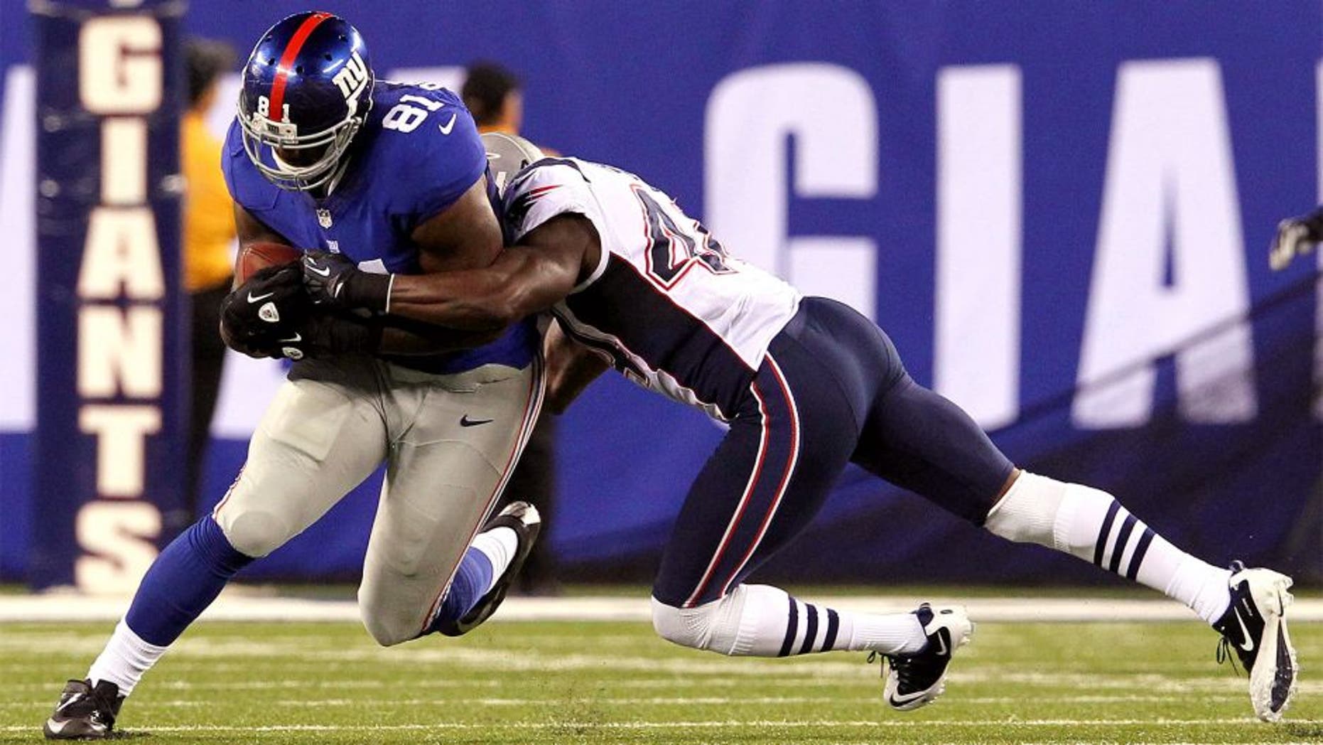 August 29, 2012; East Rutherford, NJ, USA; New York Giants tight end Adrien Robinson (81) is brought down by New England Patriots defensive back James Ihedigbo (44) during the third quarter of a preseason game at MetLife Stadium. Mandatory Credit: Brad Penner-USA TODAY Sports