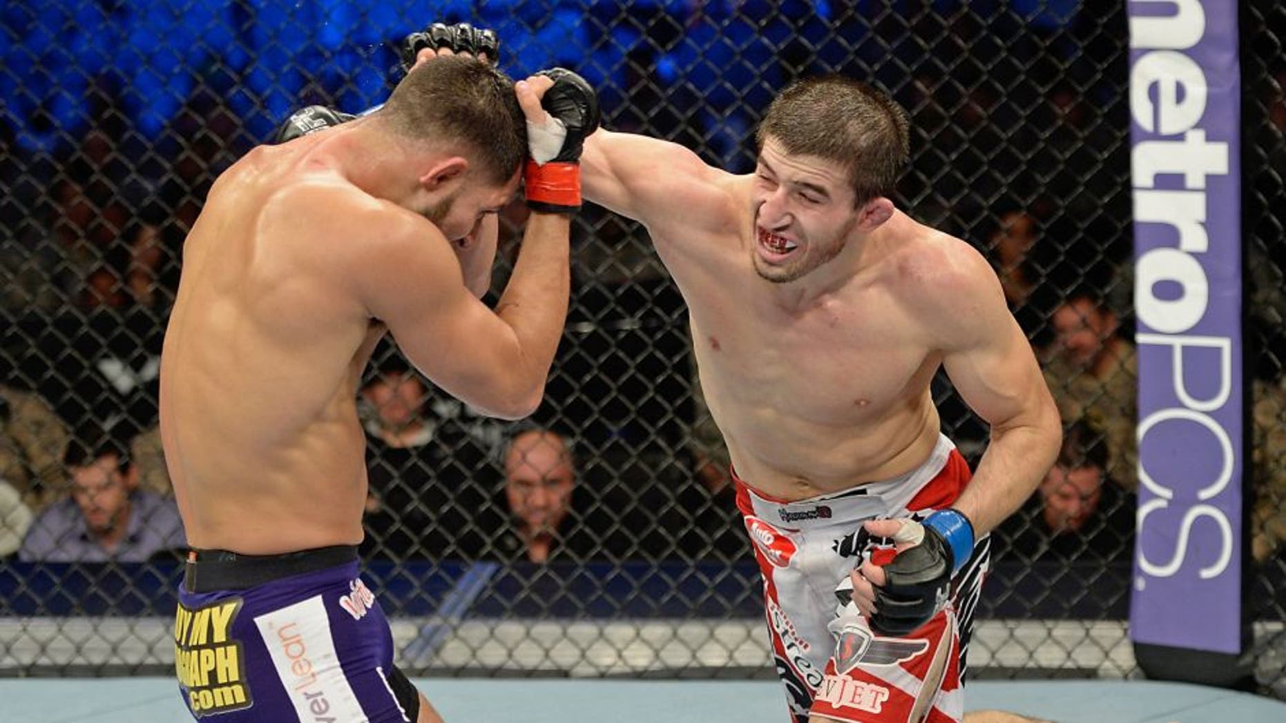 FORT CAMPBELL, KENTUCKY - NOVEMBER 6: (R-L) Rustam Khabilov punches Jorge Masvidal in their UFC lightweight bout on November 6, 2013 in Fort Campbell, Kentucky. (Photo by Jeff Bottari/Zuffa LLC/Zuffa LLC via Getty Images)