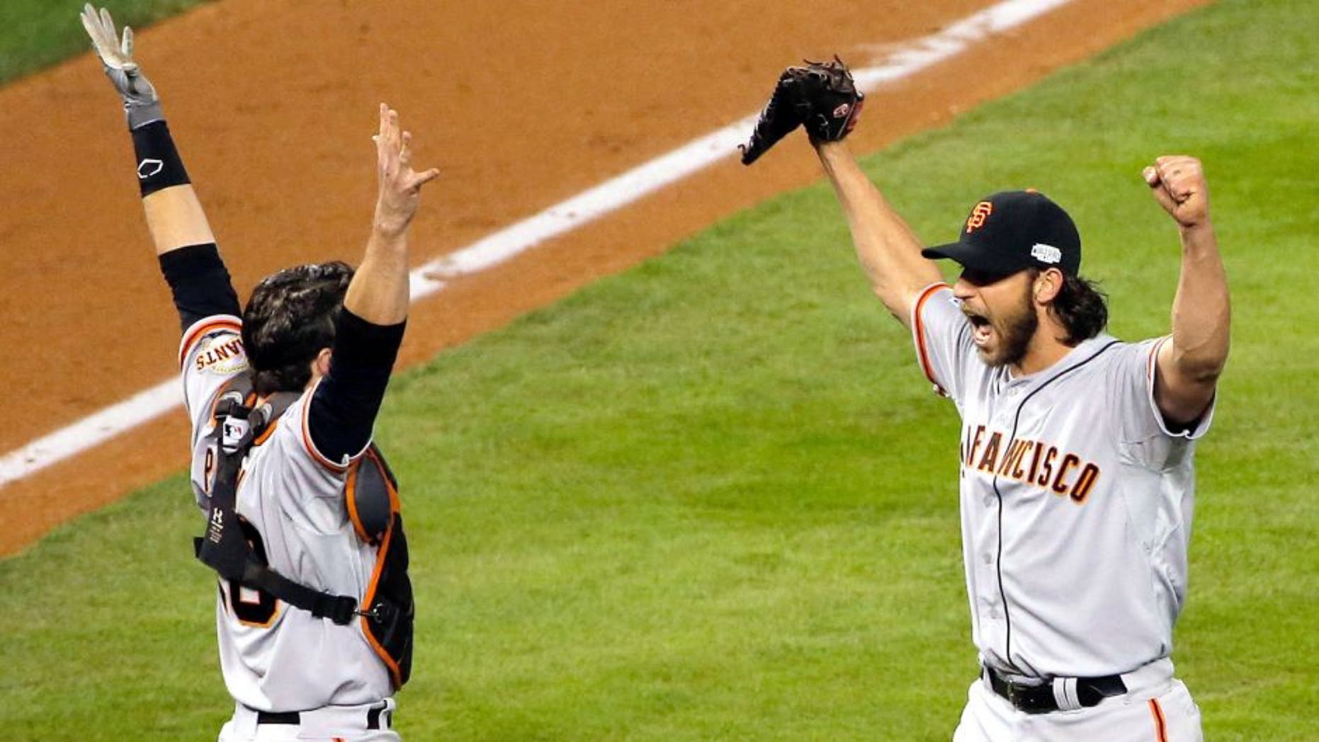 KANSAS CITY, MO - OCTOBER 29: Buster Posey #28 and Madison Bumgarner #40 of the San Francisco Giants celebrate after defeating the Kansas City Royals to win Game Seven of the 2014 World Series by a score of 3-2 at Kauffman Stadium on October 29, 2014 in Kansas City, Missouri. (Photo by Doug Pensinger/Getty Images)