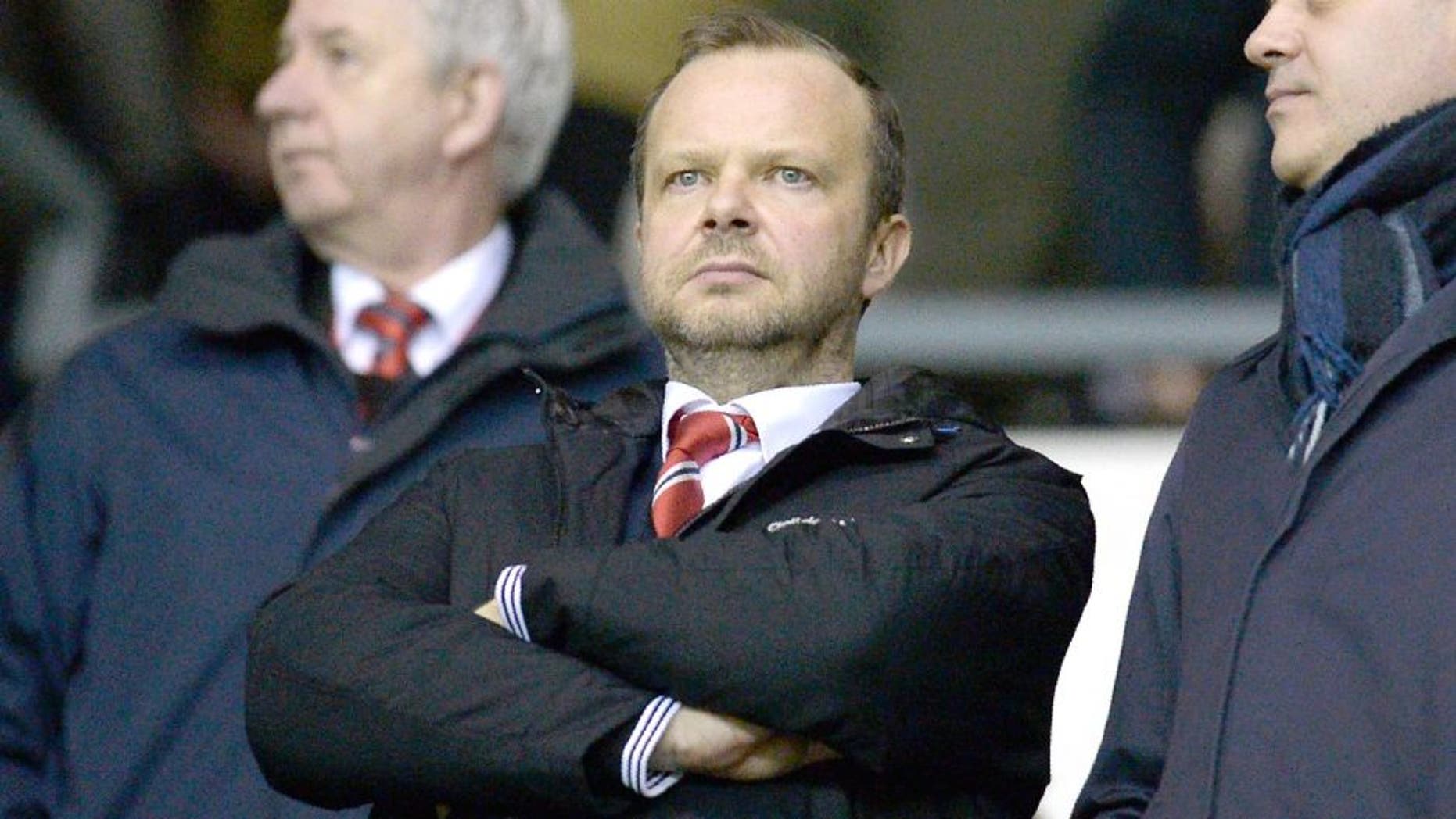 Manchester United's executive vice-chairman Ed Woodward (C) stands in the crowd ahead of the FA cup fourth round football match between Derby County and Manchester United at Pride Park stadium in Derby on January 29, 2016. / AFP / OLI SCARFF / RESTRICTED TO EDITORIAL USE. No use with unauthorized audio, video, data, fixture lists, club/league logos or 'live' services. Online in-match use limited to 75 images, no video emulation. No use in betting, games or single club/league/player publications. / (Photo credit should read OLI SCARFF/AFP/Getty Images)