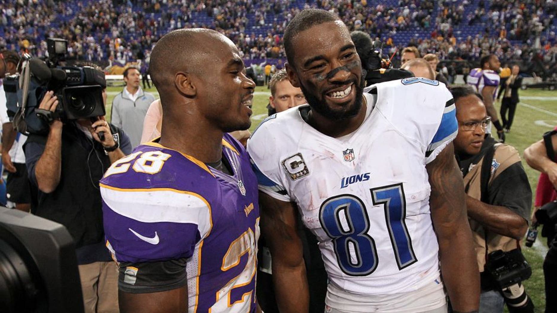 Nov 11, 2012; Minneapolis, MN, USA; Detroit Lions wide receiver Calvin Johnson (81) talks with Minnesota Vikings running back Adrian Peterson (28) following the game at the Metrodome. The Vikings defeated the Lions 34-24. Mandatory Credit: Brace Hemmelgarn-USA TODAY Sports