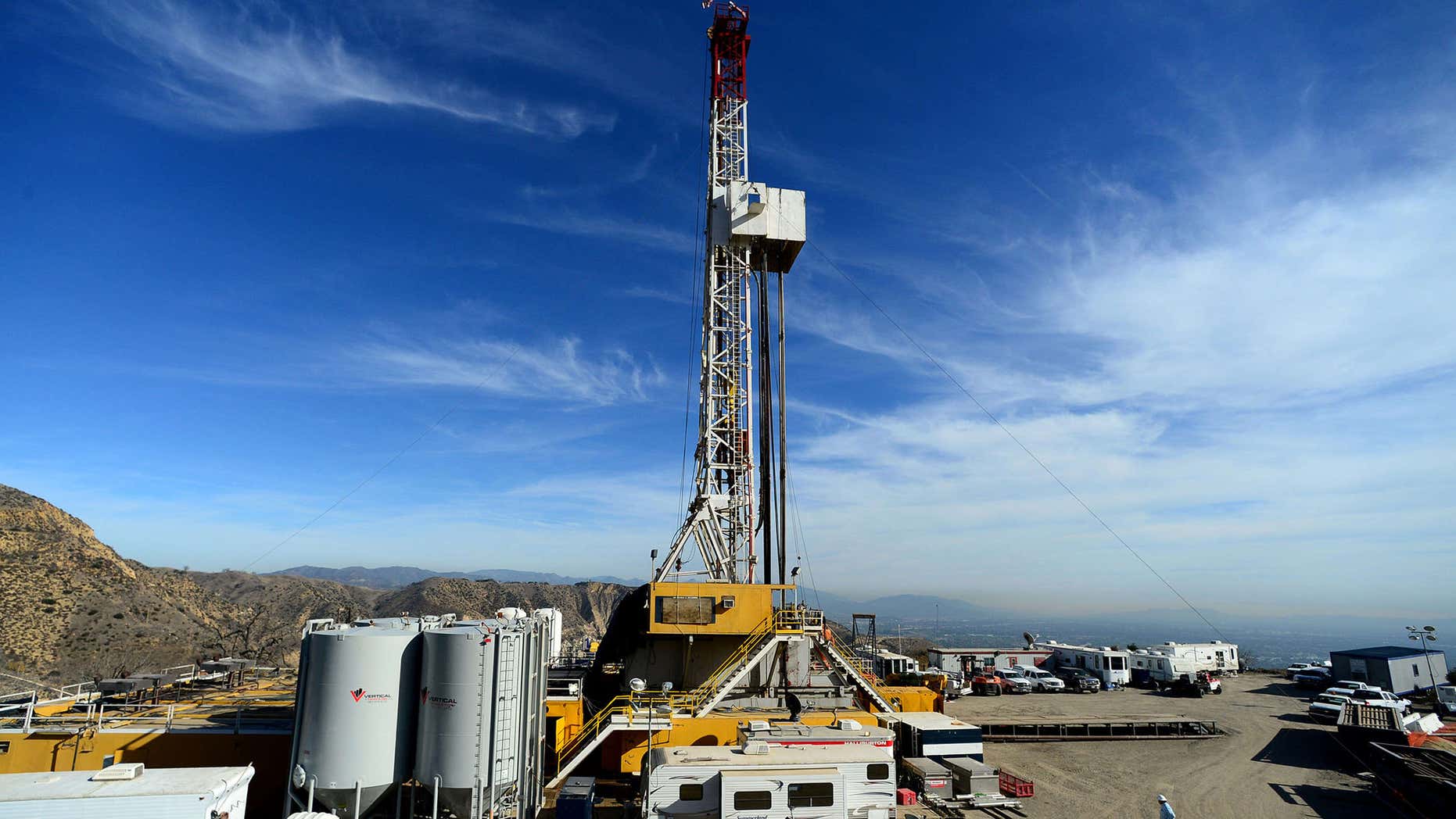 FILE - In this Dec. 9, 2015, pool file photo, crews work on stopping a gas leak at a relief well at the Aliso Canyon facility above the Porter Ranch area of Los Angeles.