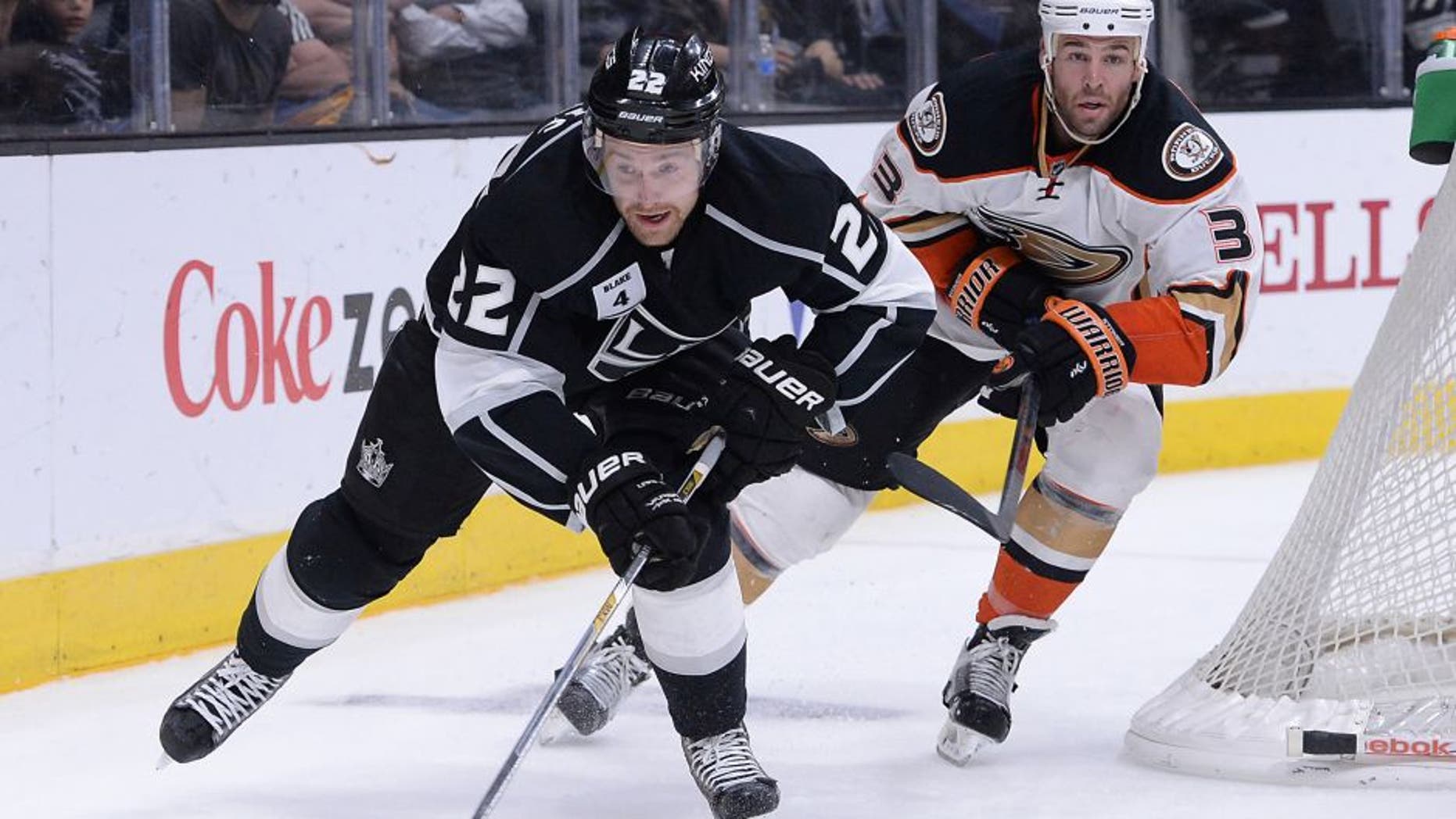 Jan 17, 2015; Los Angeles, CA, USA; Anaheim Ducks defenseman Clayton Stoner (3) and Los Angeles Kings center Trevor Lewis (22) chase down the puck in the second period of the game at Staples Center. Mandatory Credit: Jayne Kamin-Oncea-USA TODAY Sports