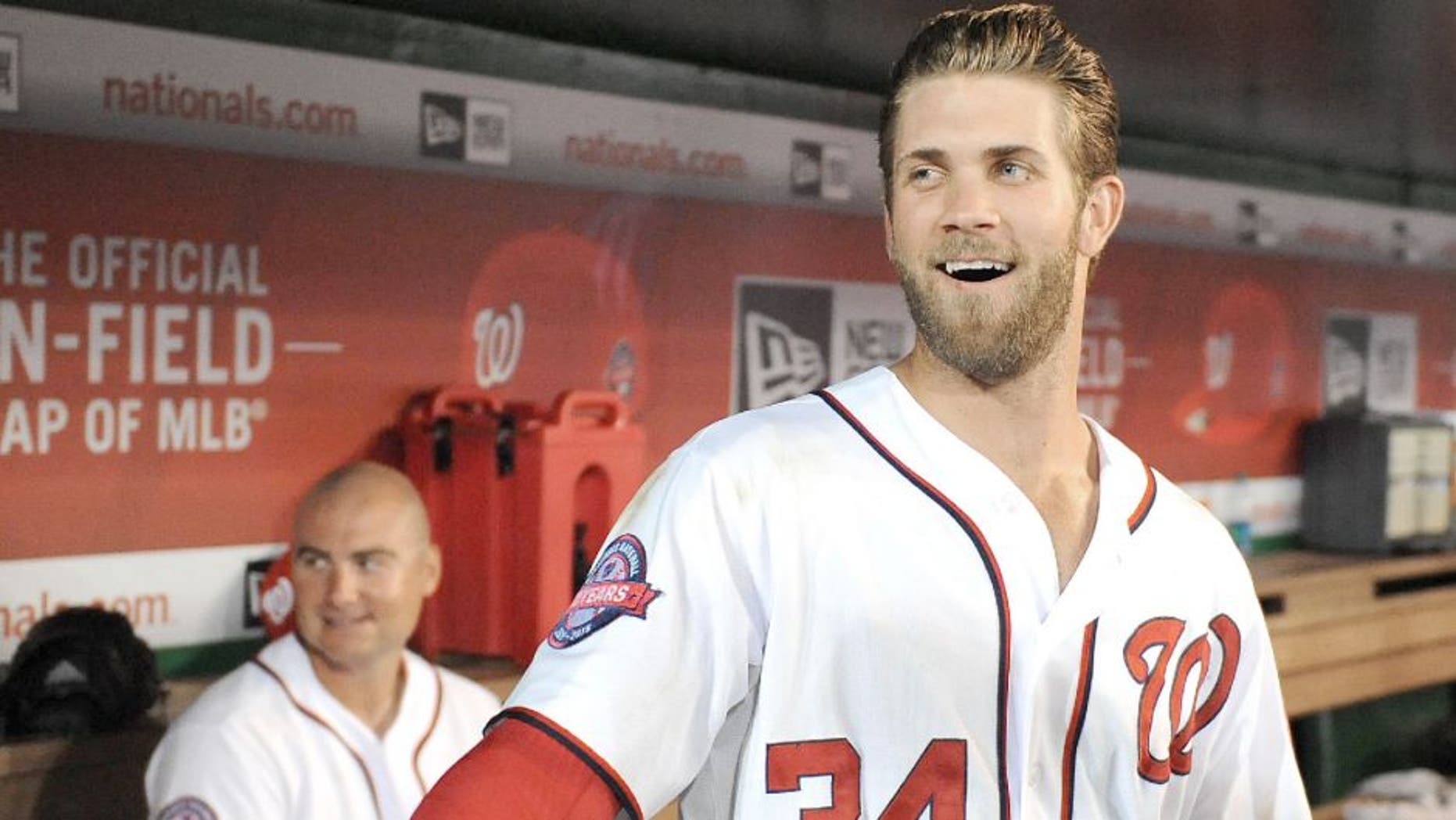 Apr 23, 2015; Washington, DC, USA; Washington Nationals right fielder Bryce Harper (34) jokes with fans during a delay in the game between the Washington Nationals and the Los Angeles Dodgers at Nationals Park. Mandatory Credit: Brad Mills-USA TODAY Sports