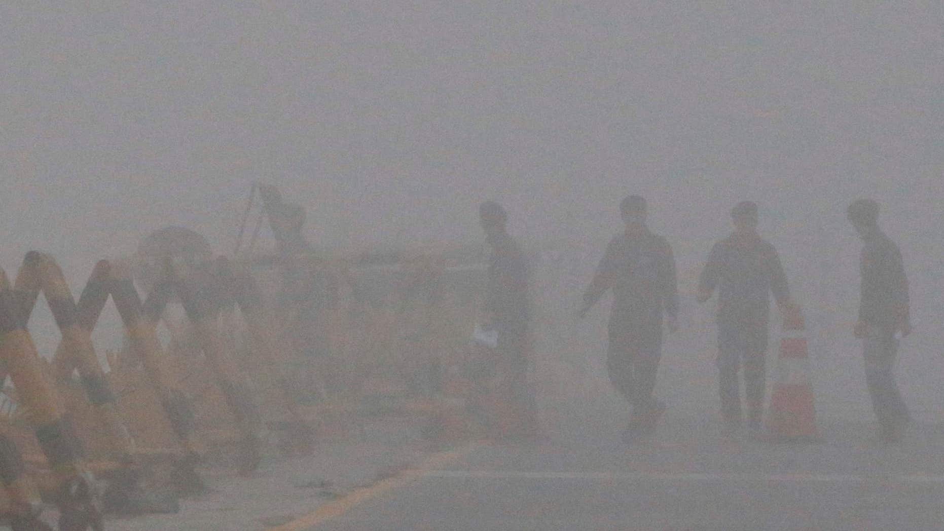 Feb. 12, 2016: South Korean Army soldiers walk on a foggy and rainy morning at Unification Bridge near the border village of Panmunjom in Paju, South Korea.